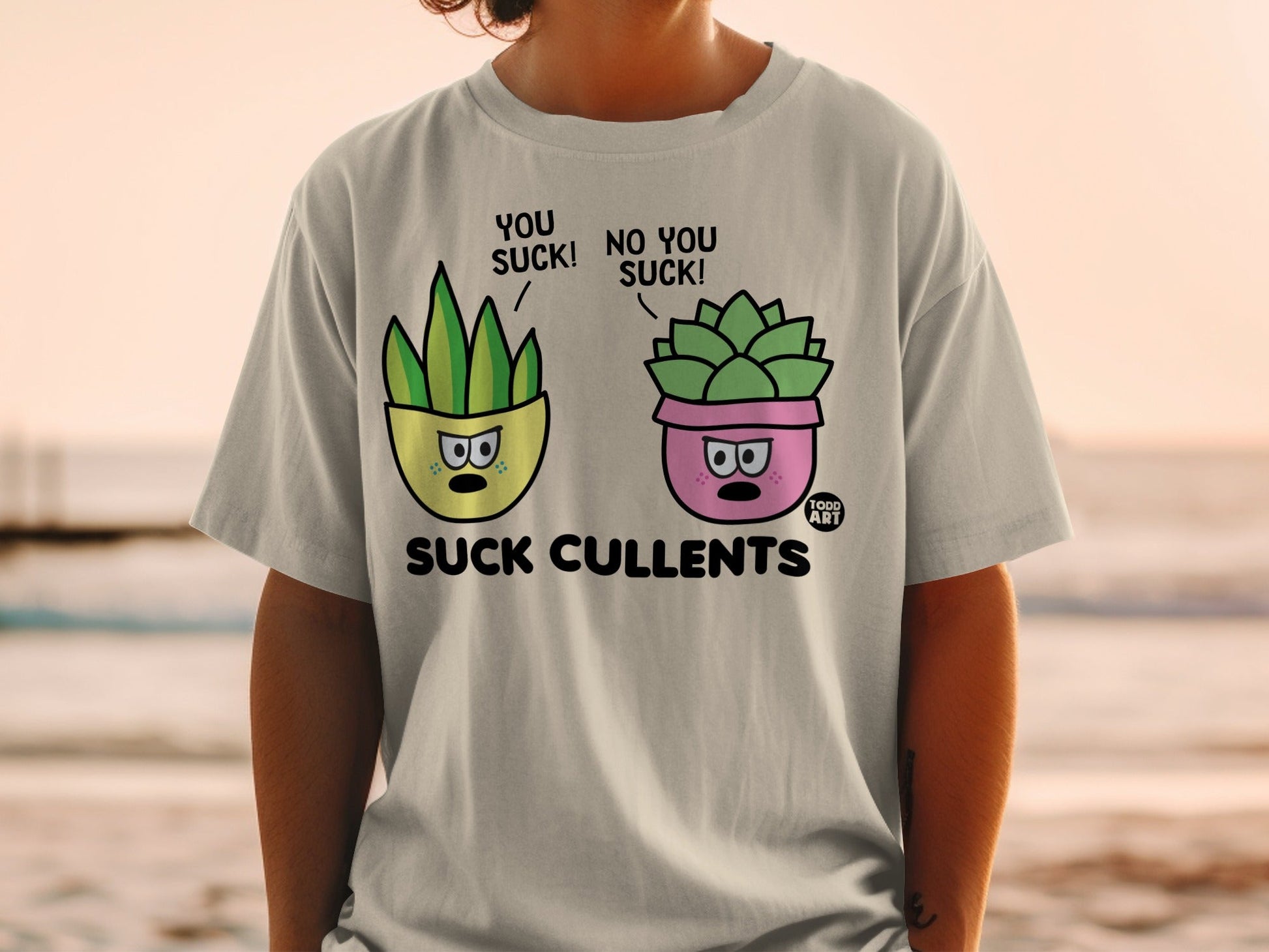T-shirt graphic of two potted succulents saying "You suck!" and "No you suck!".