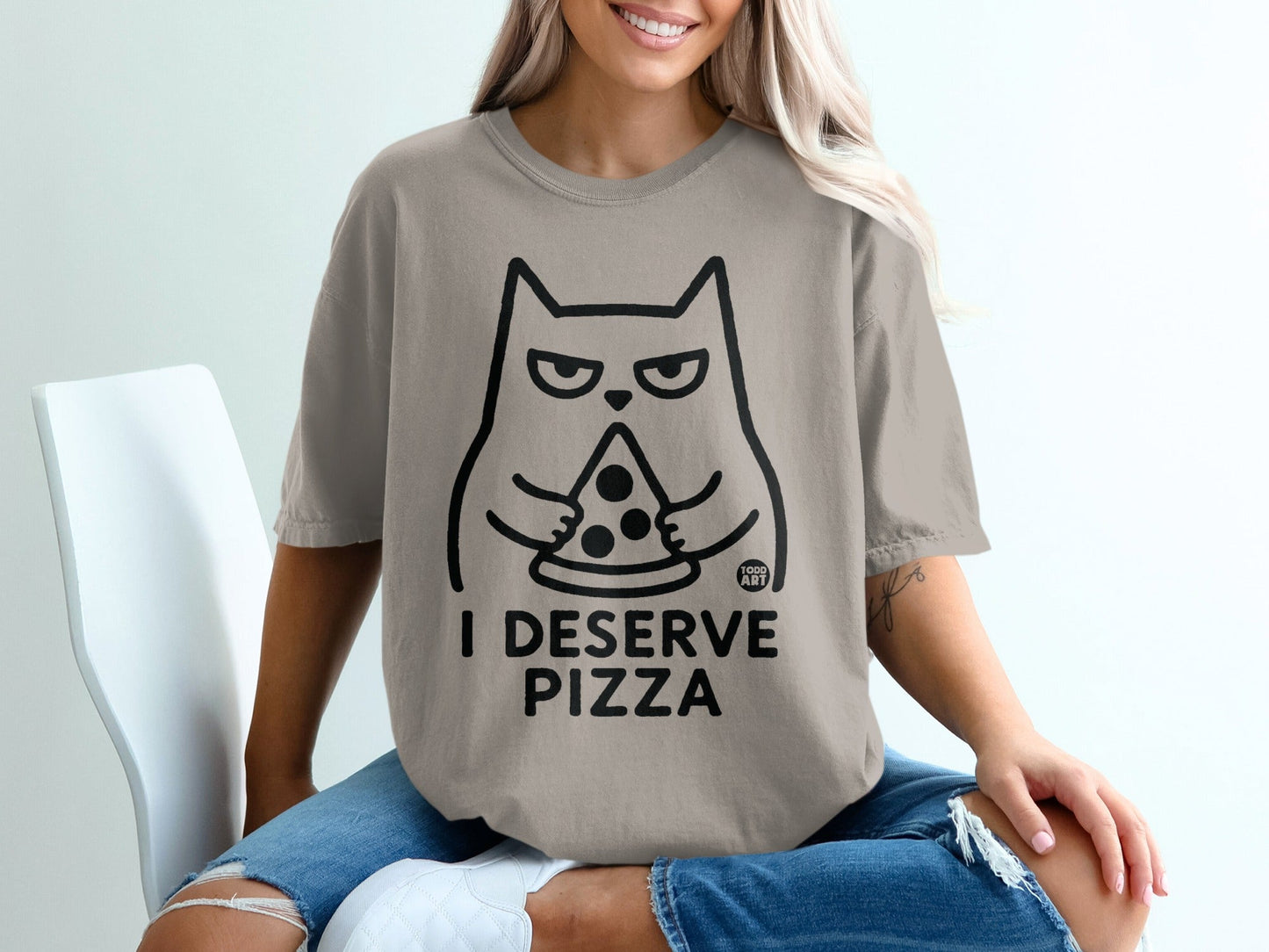 T-shirt with a graphic of a grumpy cat holding a pizza slice.