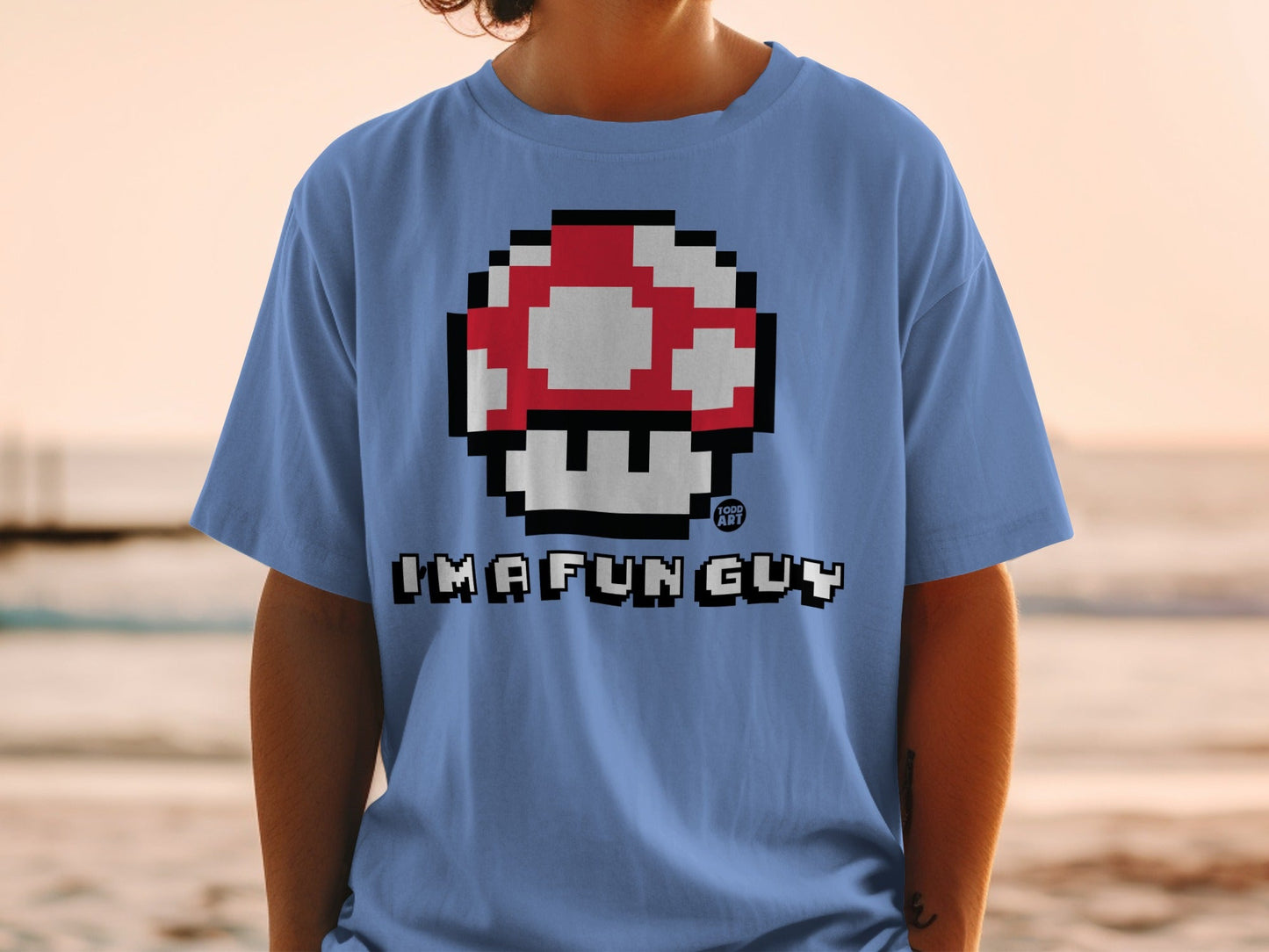Blue t-shirt with pixelated red and white mushroom and "IMAFUN GUY" text.