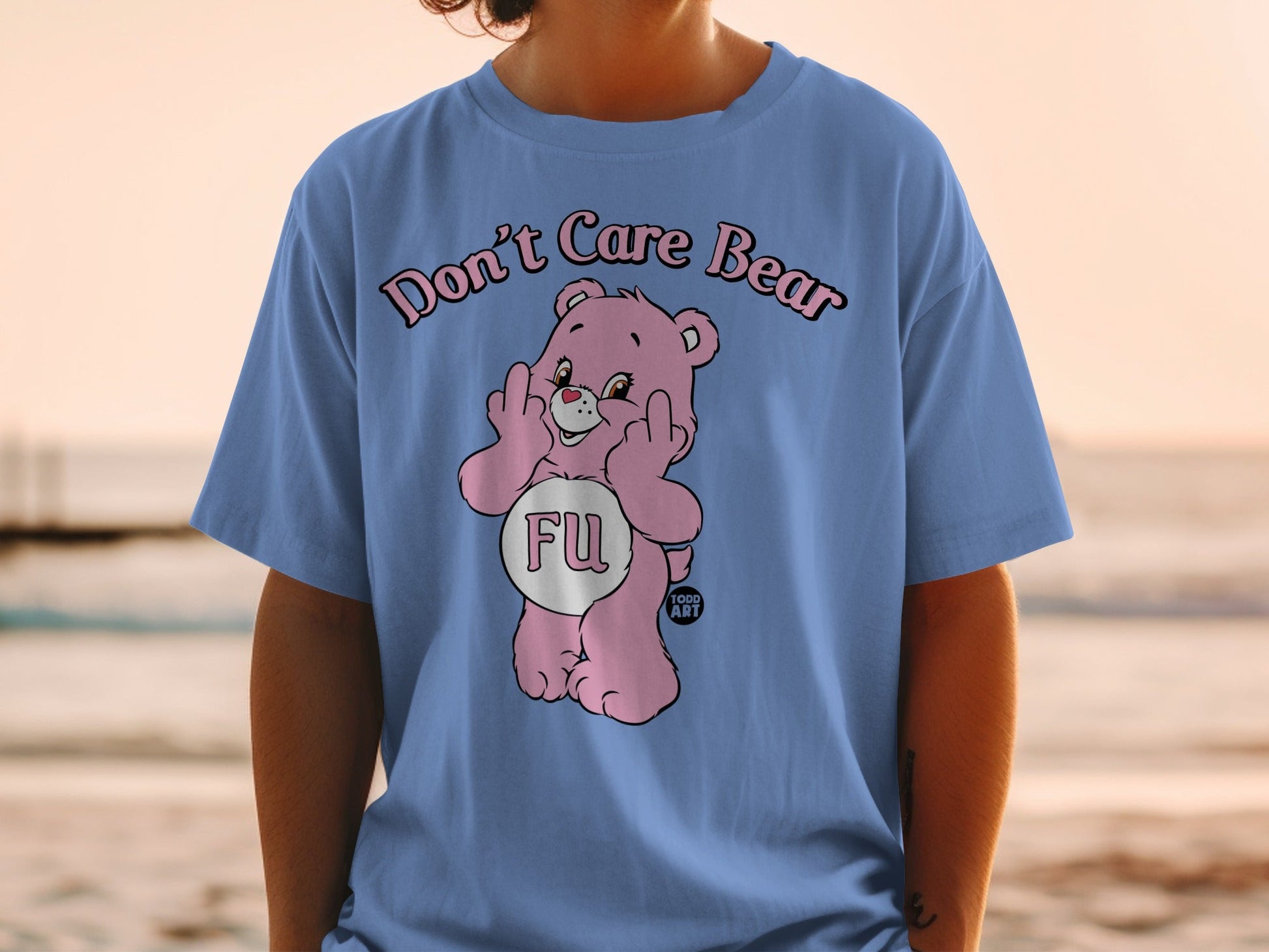 Pink Care Bear t-shirt with "Don't Care Bear" text and middle finger gesture.