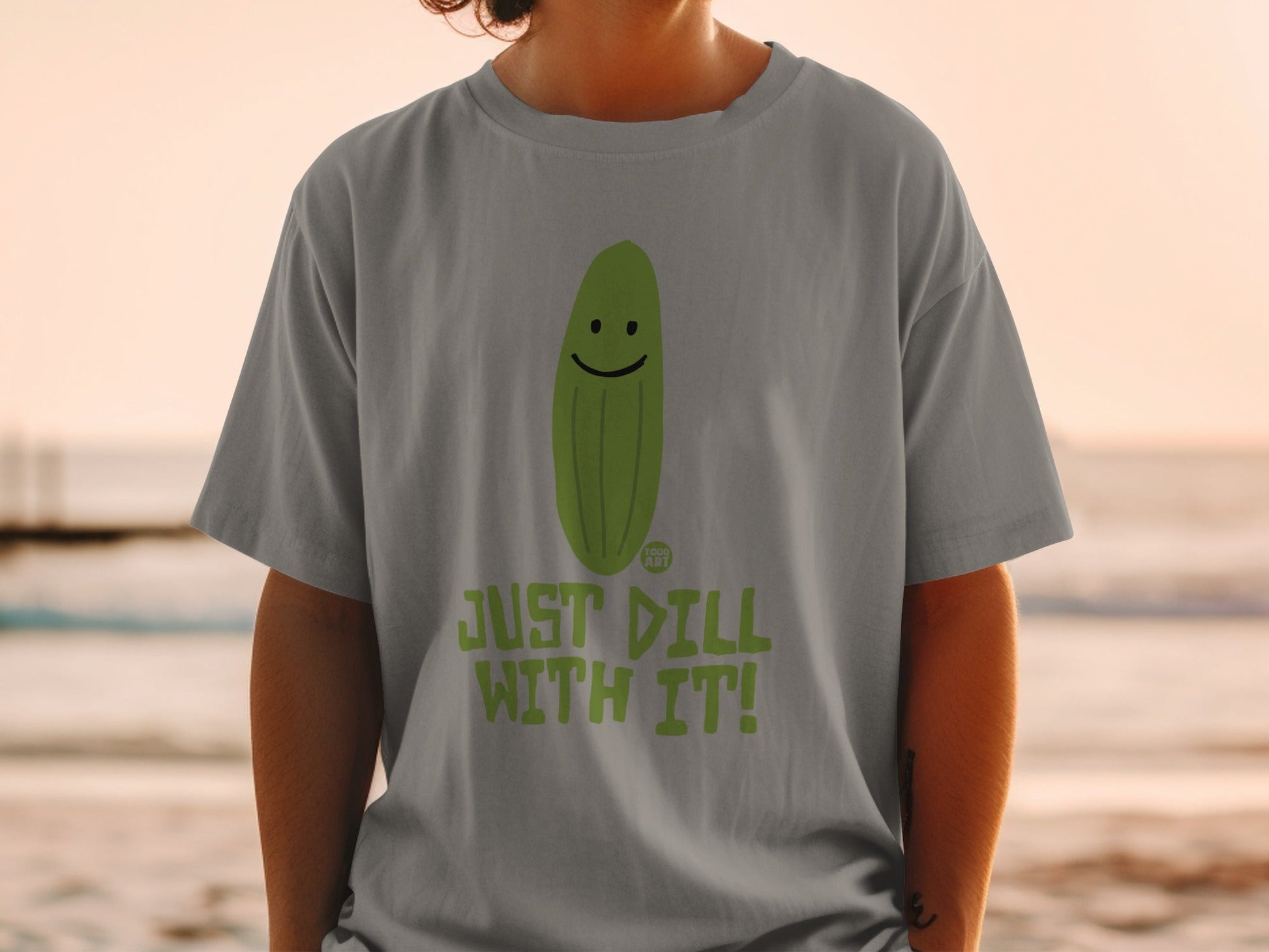 T-shirt with smiling pickle and "JUST DILL WITH IT!" text.