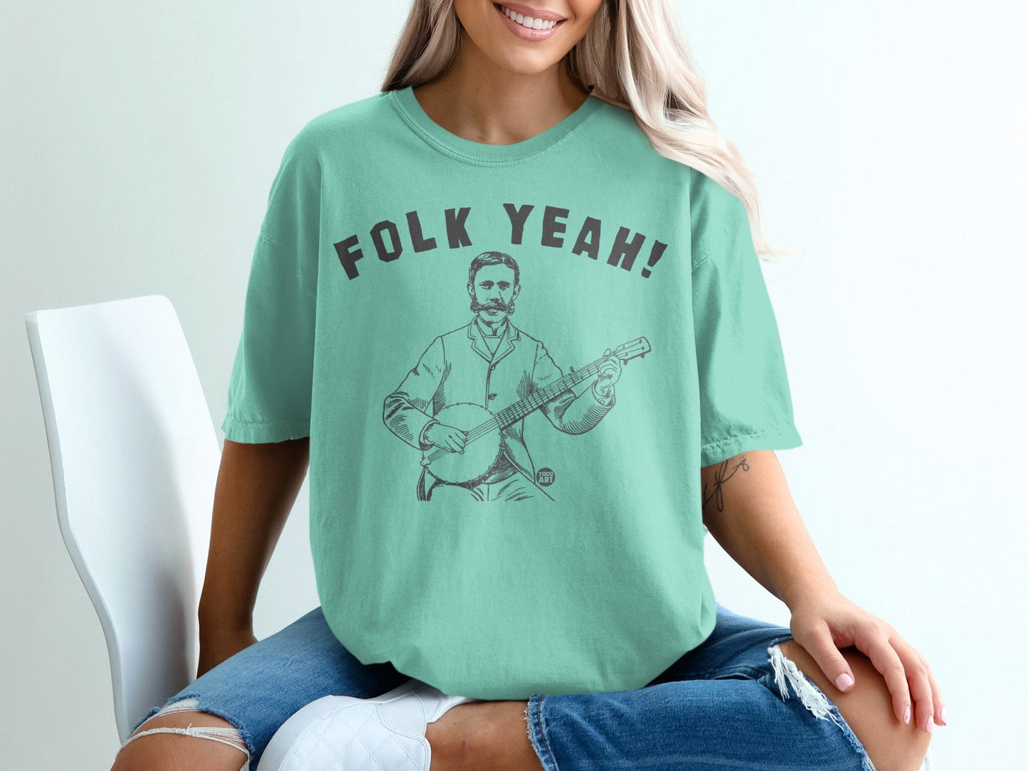 Teal t-shirt with vintage illustration and "Folk Yeah!" text.