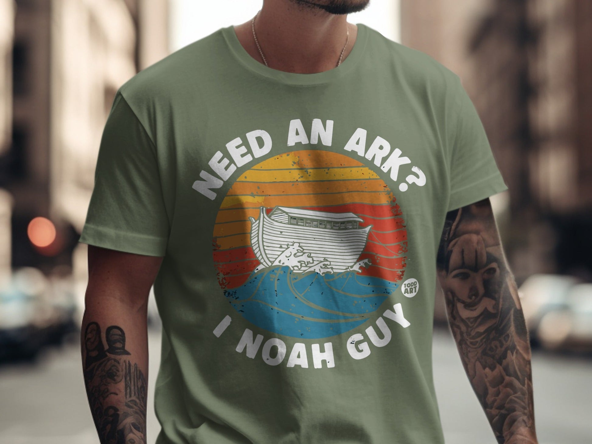 T-shirt with "Need an Ark? I Noah Guy" text and Noah's Ark graphic.