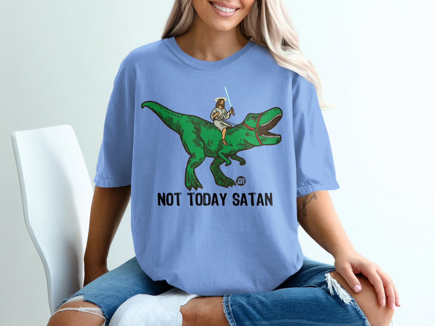 Jesus riding a dinosaur, holding a lightsaber, with text "NOT TODAY SATAN".