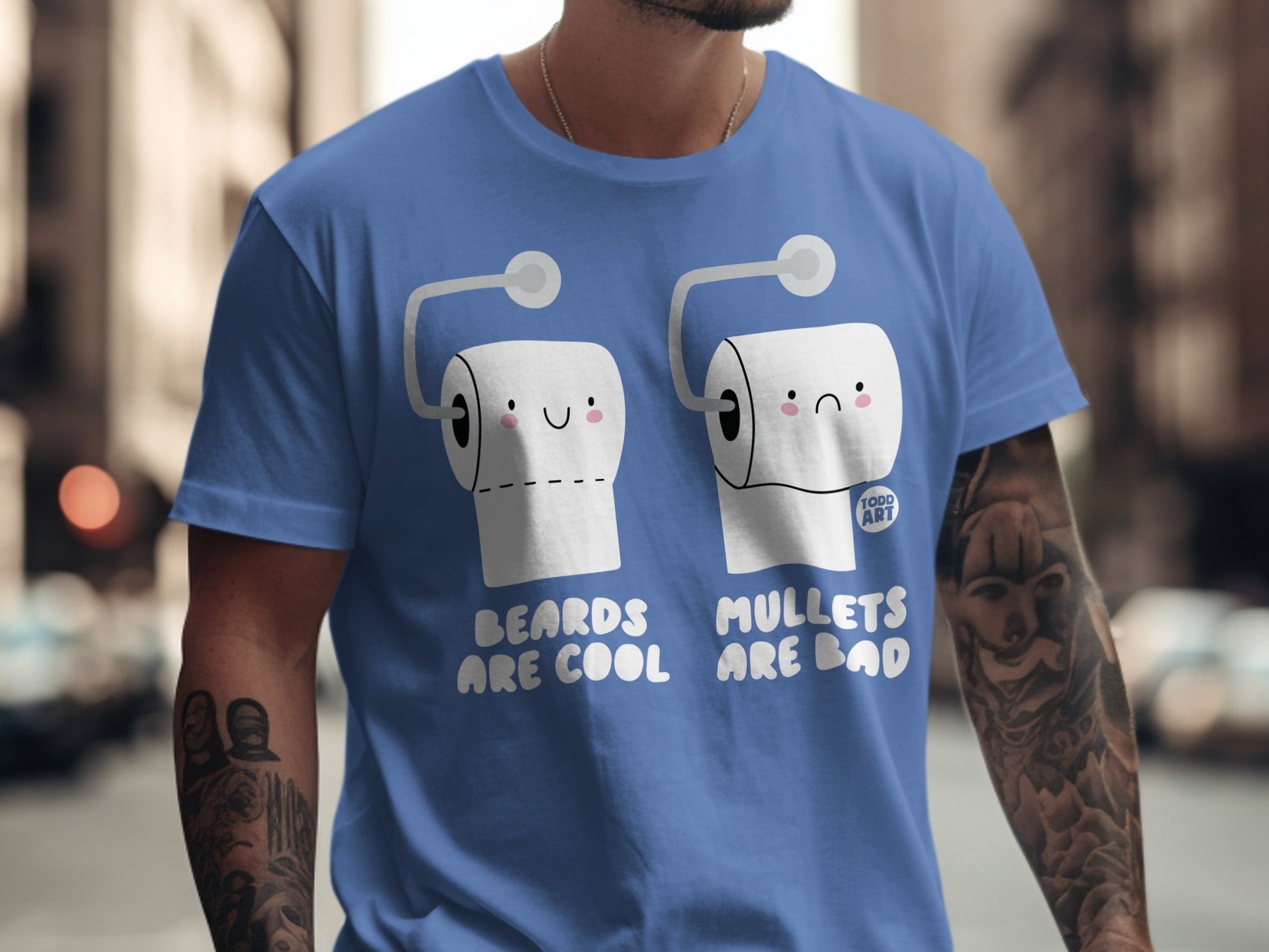 Blue t-shirt with cartoon toilet paper rolls, one happy, one sad, and text.