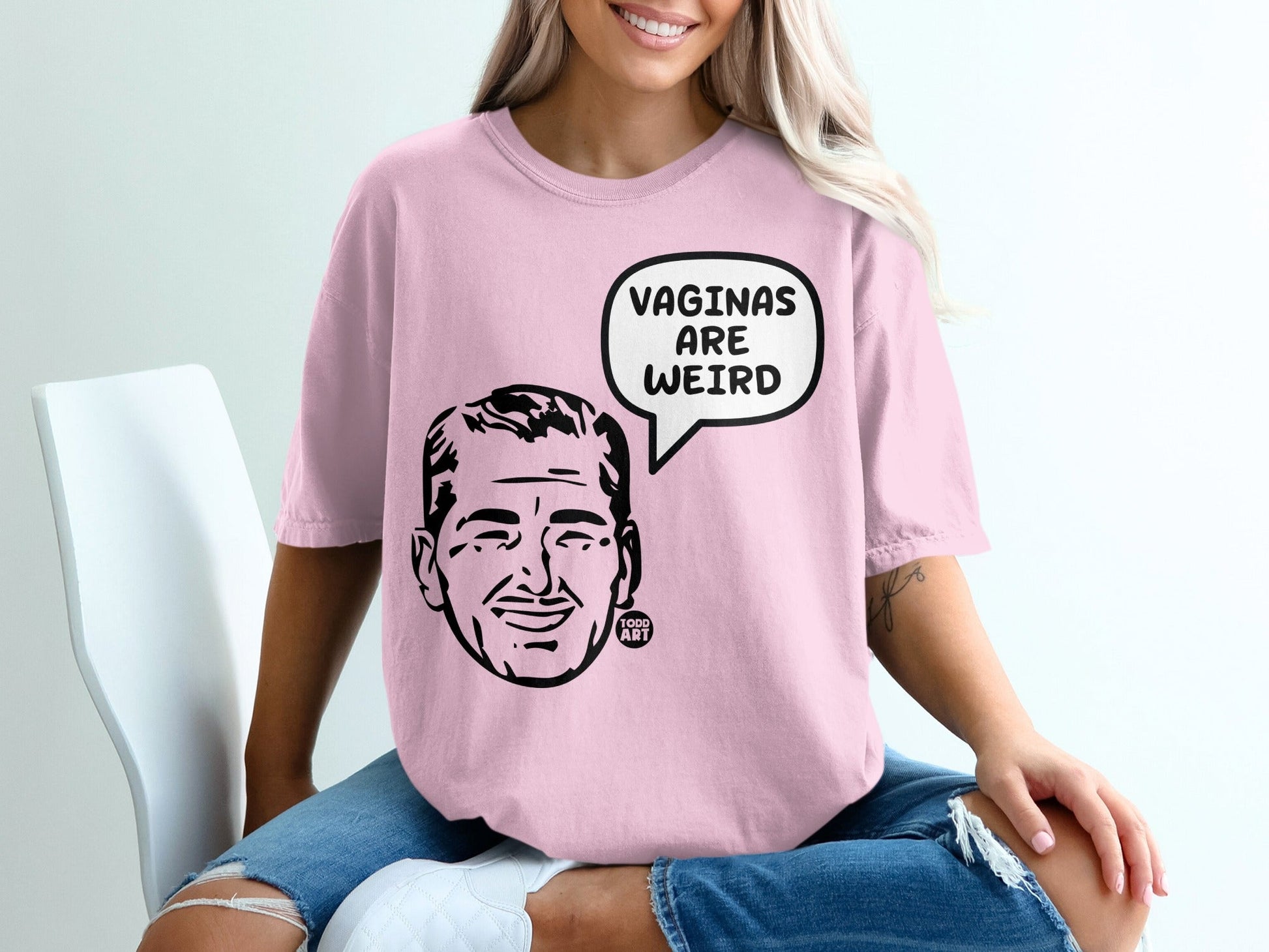 Pink t-shirt with a man's cartoon face and "VAGINAS ARE WEIRD" in a speech bubble.