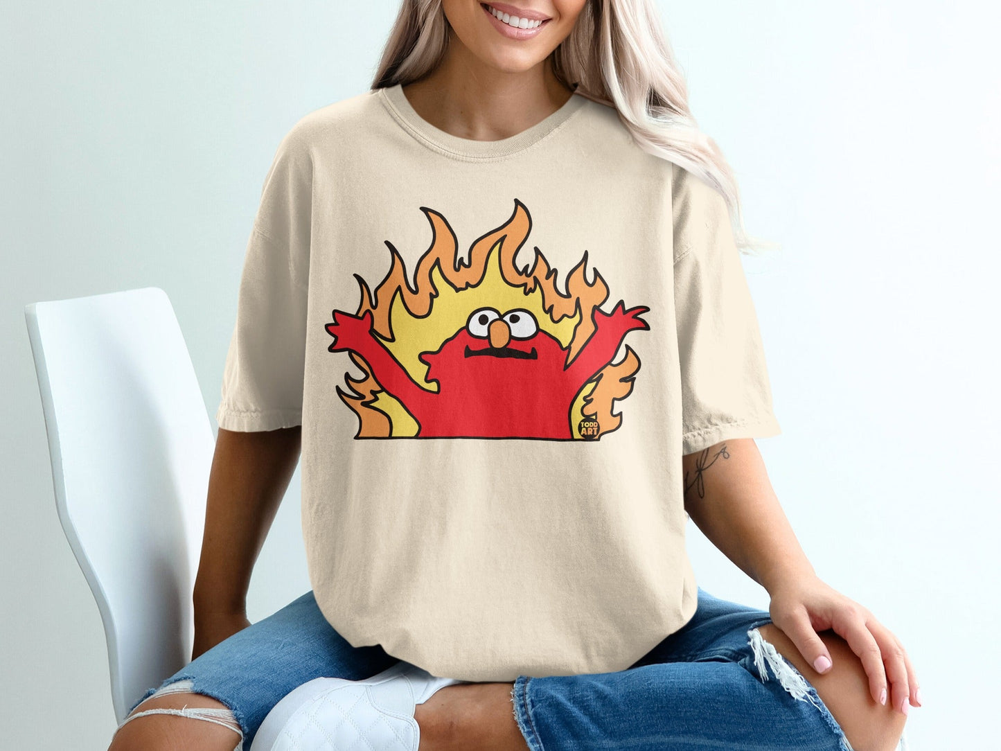 Cartoon Elmo character engulfed in flames, with arms raised.