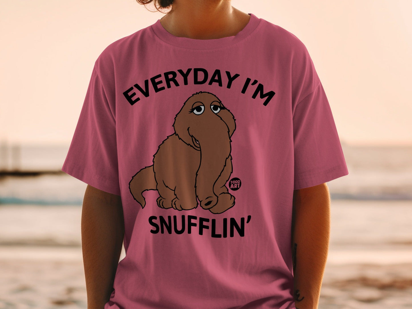Pink t-shirt with a brown cartoon character and text "EVERYDAY I'M SNUFFLIN'".
