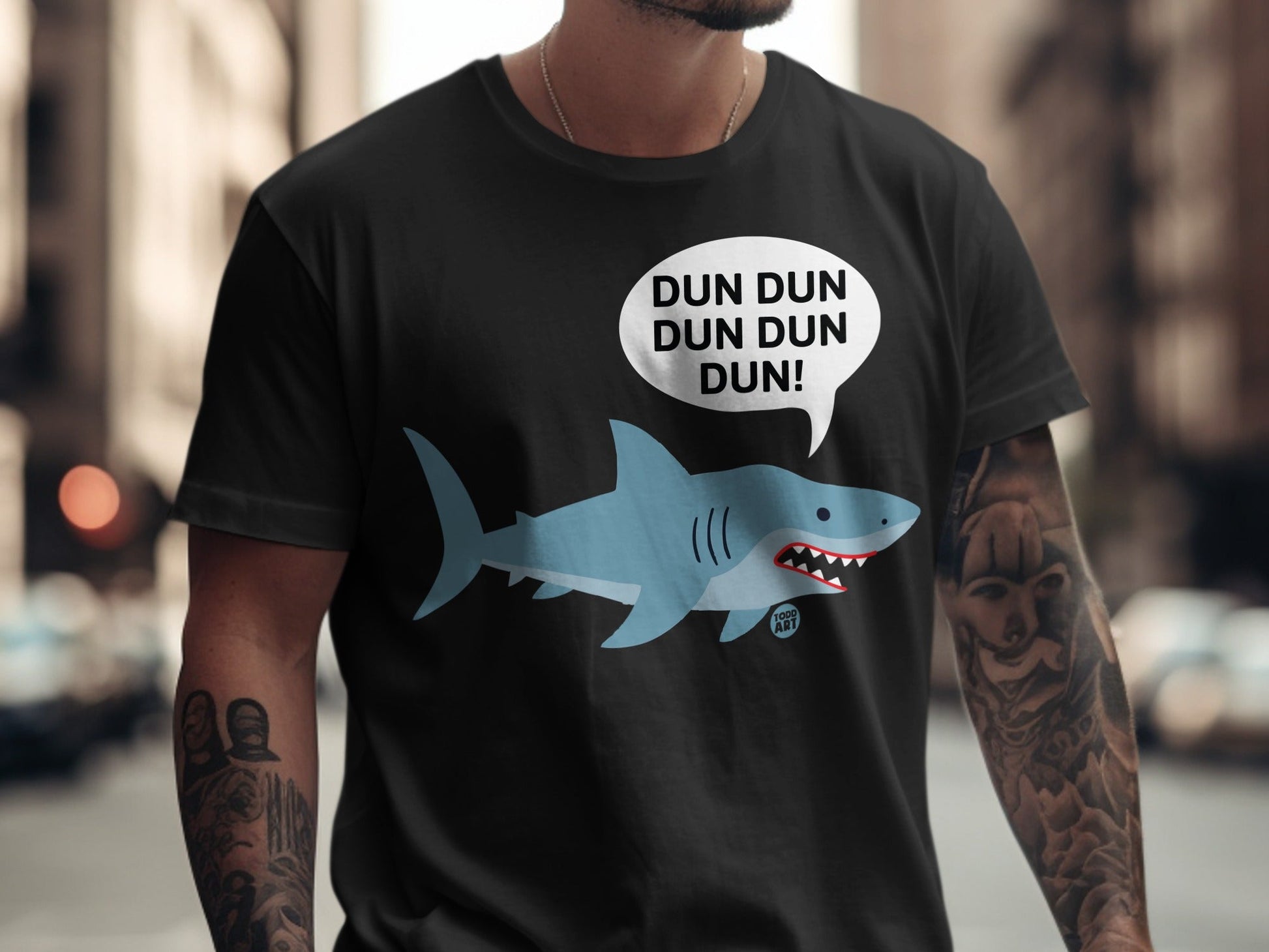 Black t-shirt featuring a cartoon shark and "DUN DUN DUN DUN!" speech bubble.