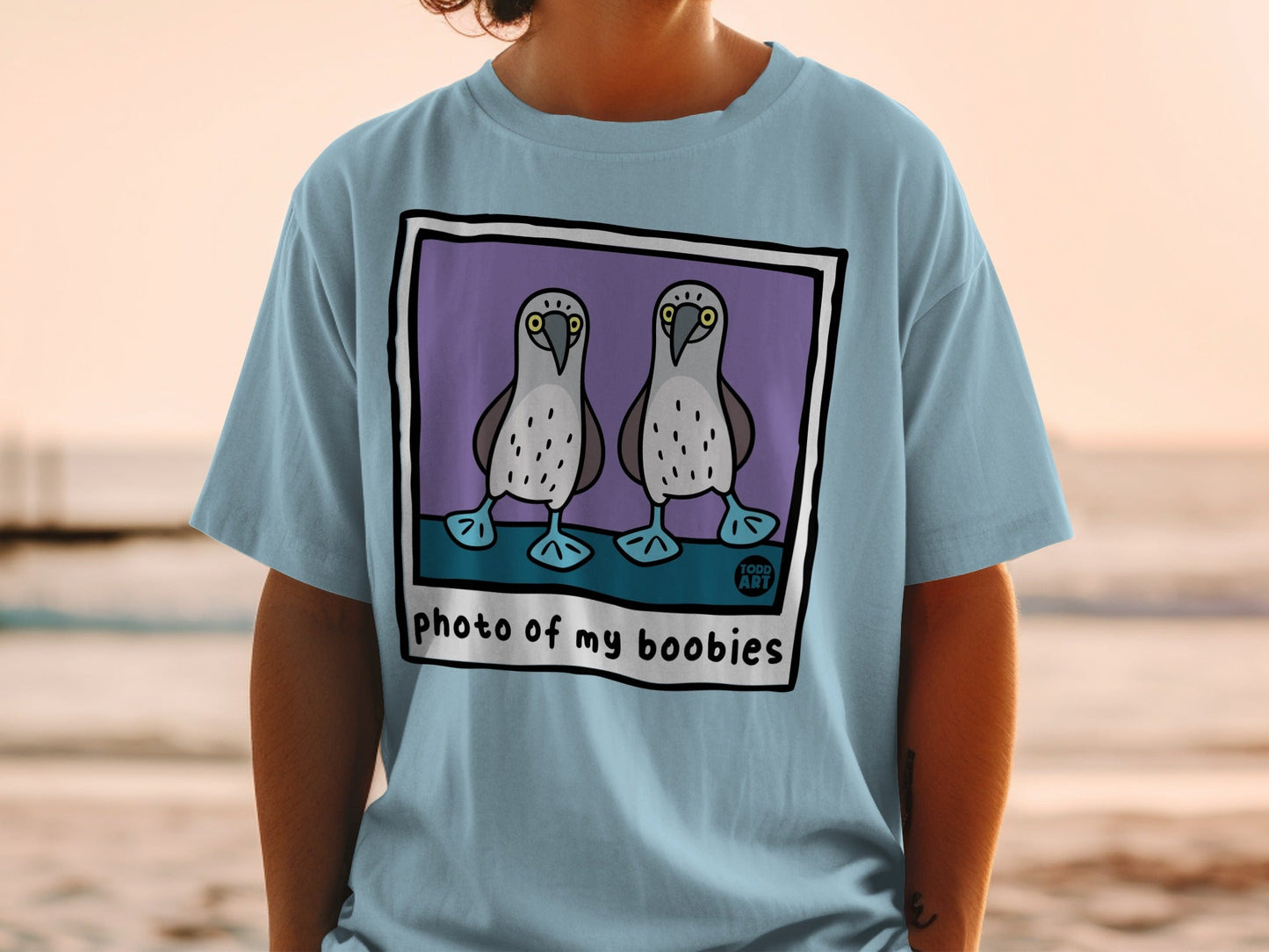Light blue t-shirt with "photo of my boobies" text and cartoon blue-footed boobies.