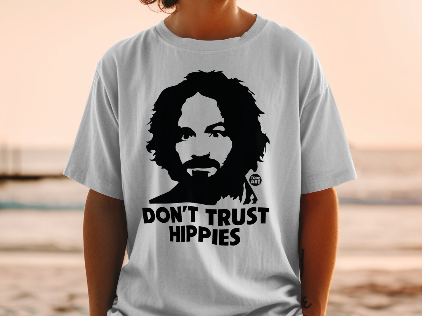 White t-shirt with Charles Manson graphic and "DON'T TRUST HIPPIES" text.