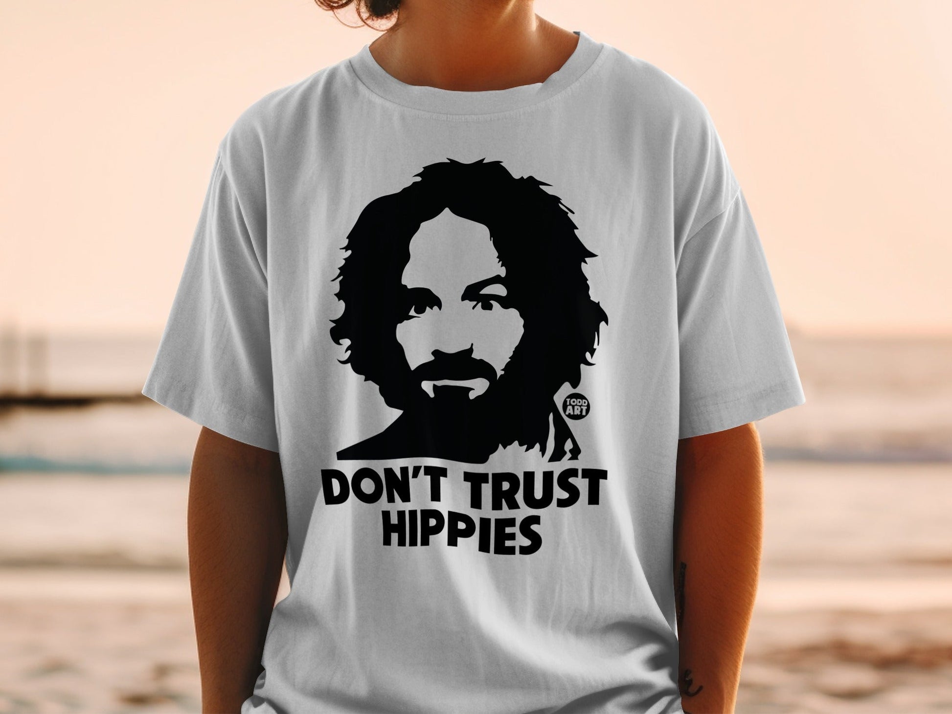 White t-shirt with Charles Manson graphic and "DON'T TRUST HIPPIES" text.