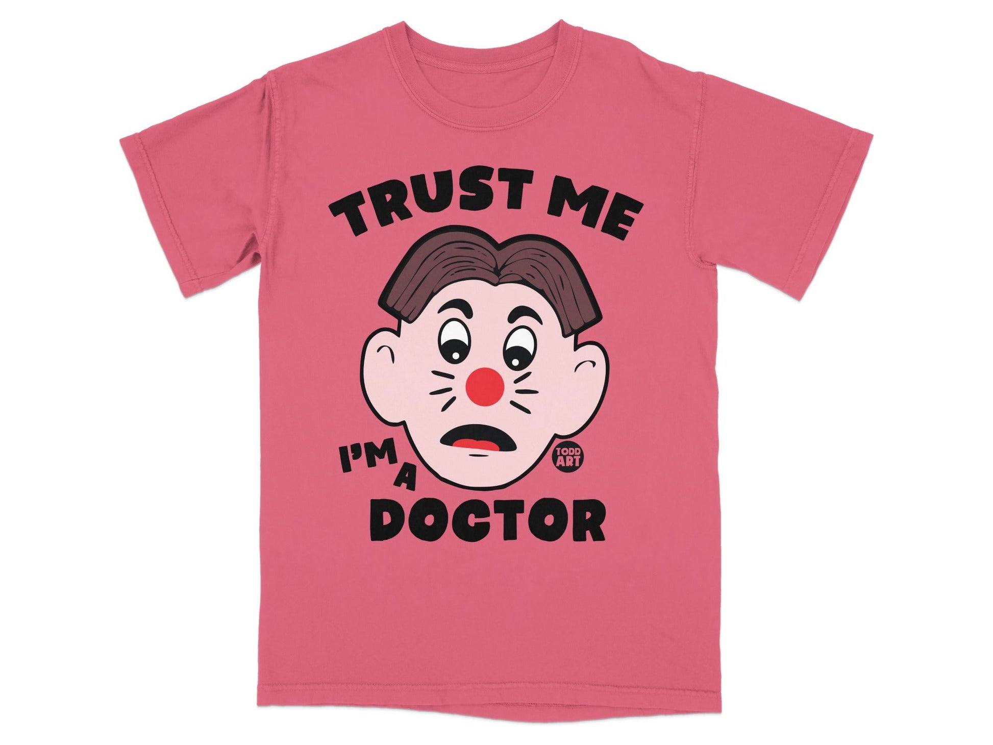 Pink t-shirt with a cartoon face and text "TRUST ME I'M A DOCTOR".
