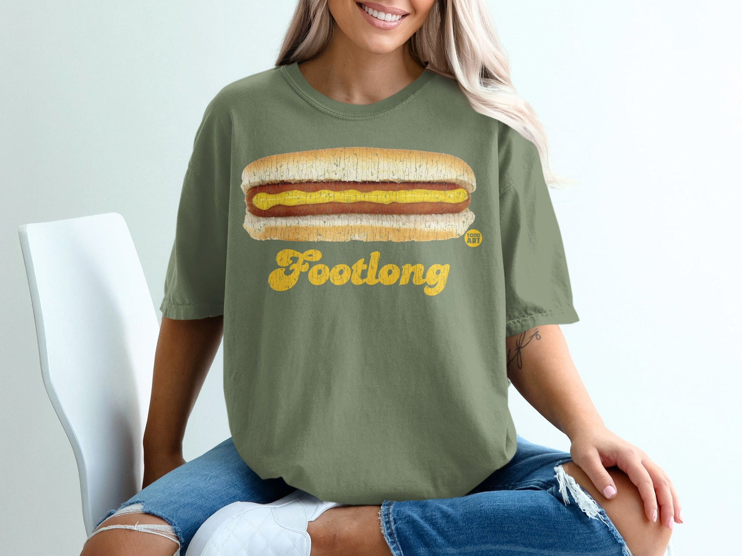 Green t-shirt with "Footlong" text and a hot dog graphic.