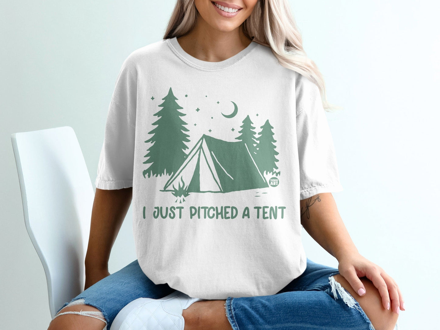 White t-shirt with green camping graphic and "I JUST PITCHED A TENT" text.