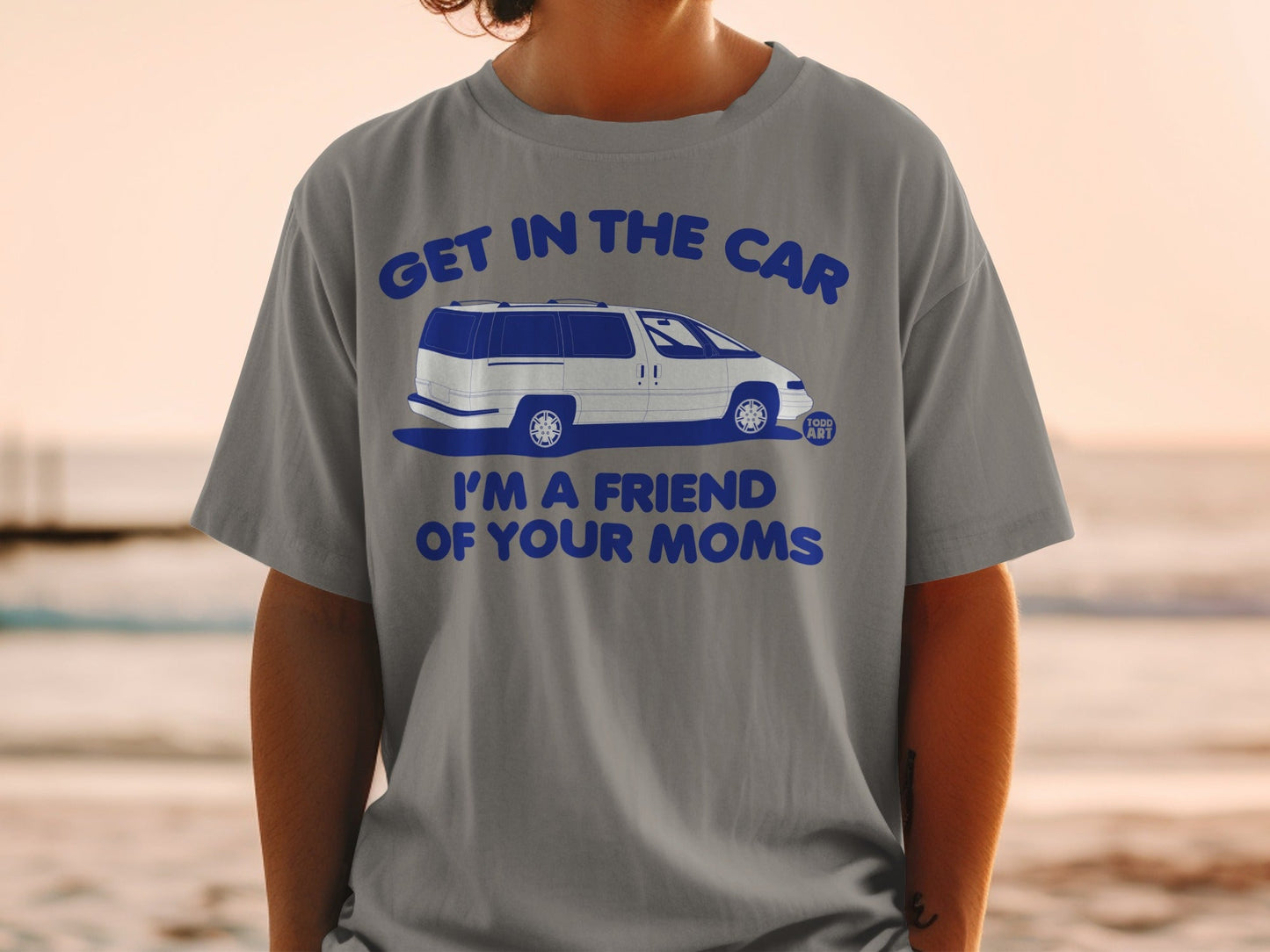 Grey t-shirt with blue text "GET IN THE CAR I'M A FRIEND OF YOUR MOMS" and a white van.