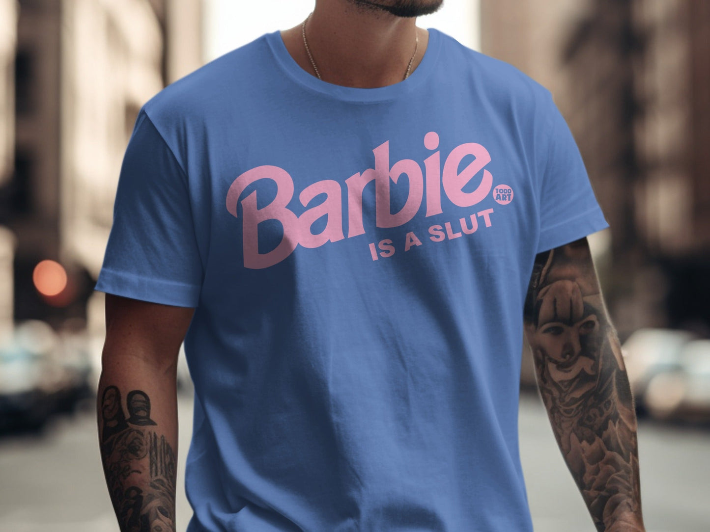 Blue t-shirt with pink "Barbie IS A SLUT" text and tattoo.