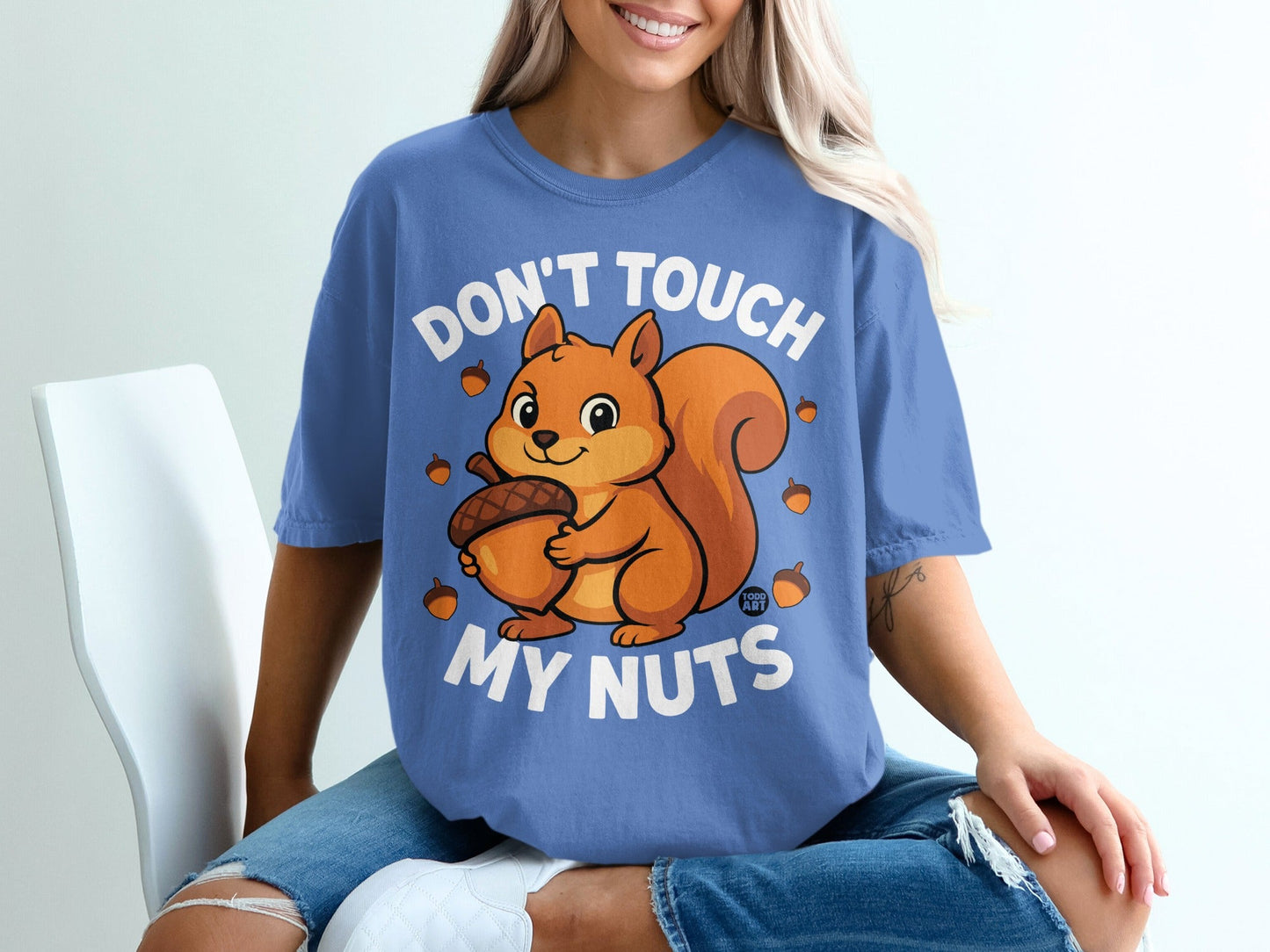 Blue t-shirt with "Don't Touch My Nuts" and cartoon squirrel holding acorn.