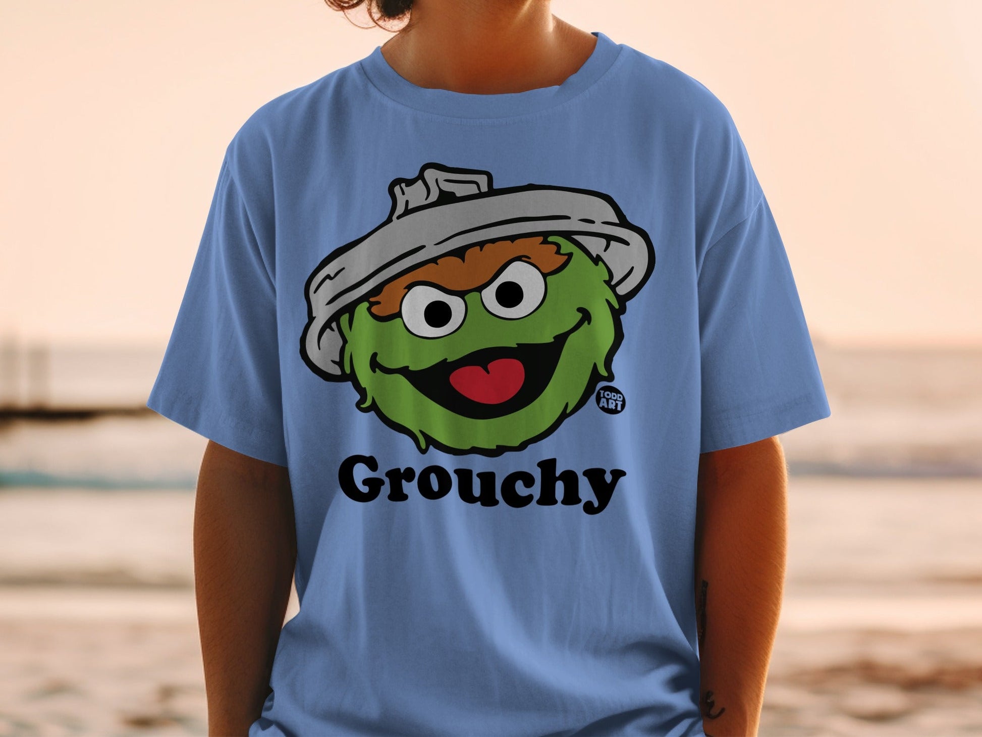 Light blue t-shirt featuring Oscar the Grouch from Sesame Street.
