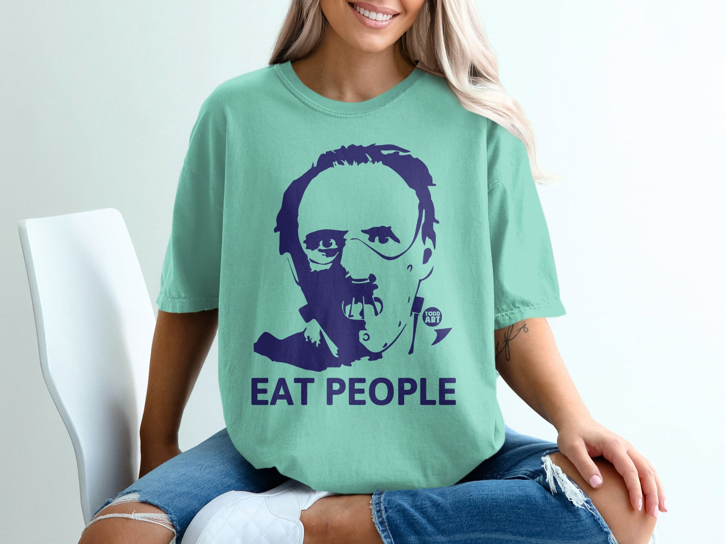 Teal t-shirt with a portrait of Hannibal Lecter and "EAT PEOPLE" text.