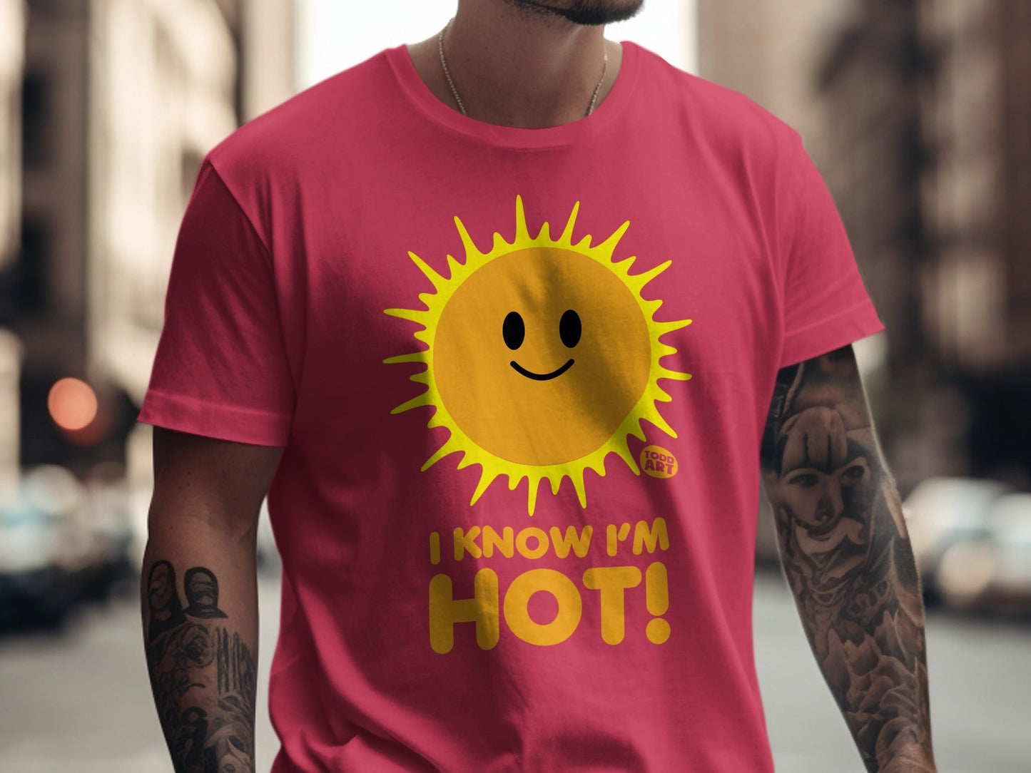 Pink t-shirt with a smiling sun graphic and the text "I KNOW I'M HOT!".