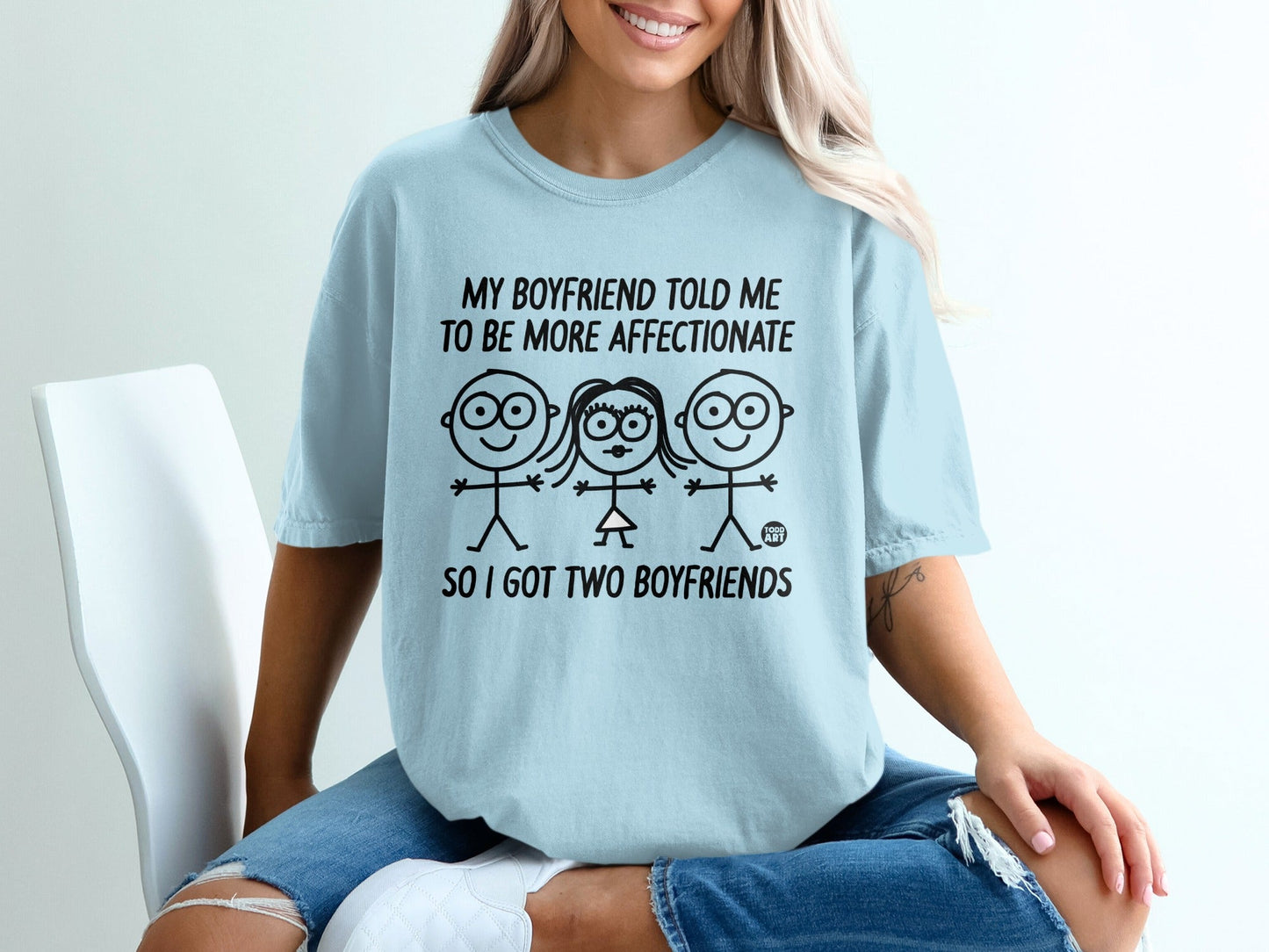 Light blue t-shirt with cartoon figures and text "My boyfriend told me to be more affectionate so I got two boyfriends."