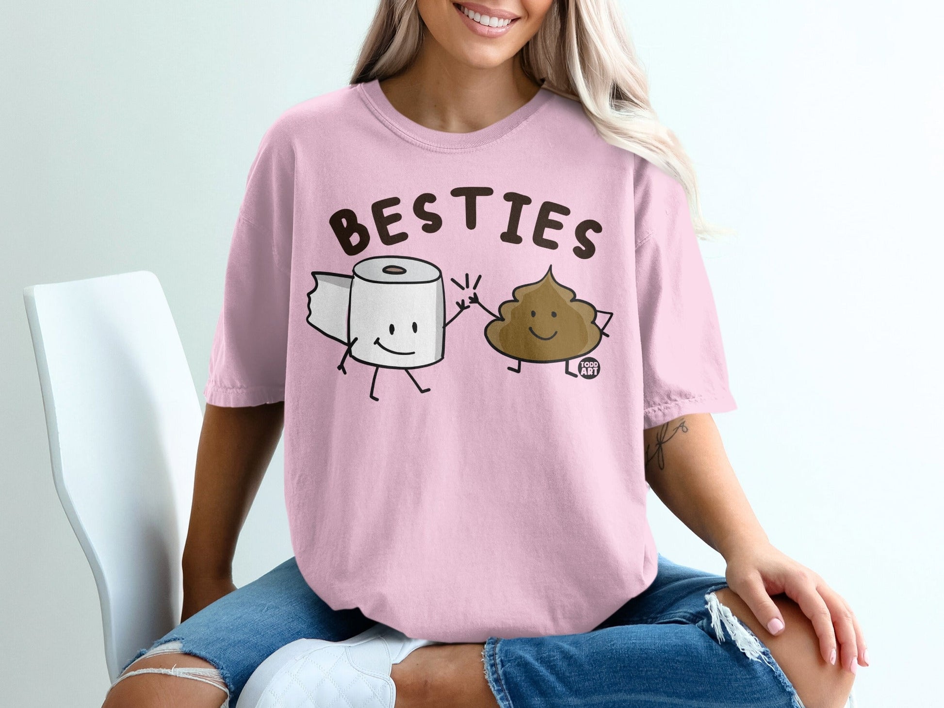 Pink t-shirt with cartoon toilet paper and poop characters saying "BESTIES".