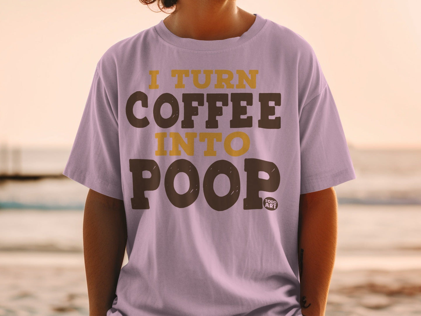 Lilac t-shirt with "I TURN COFFEE INTO POOP" printed on it.