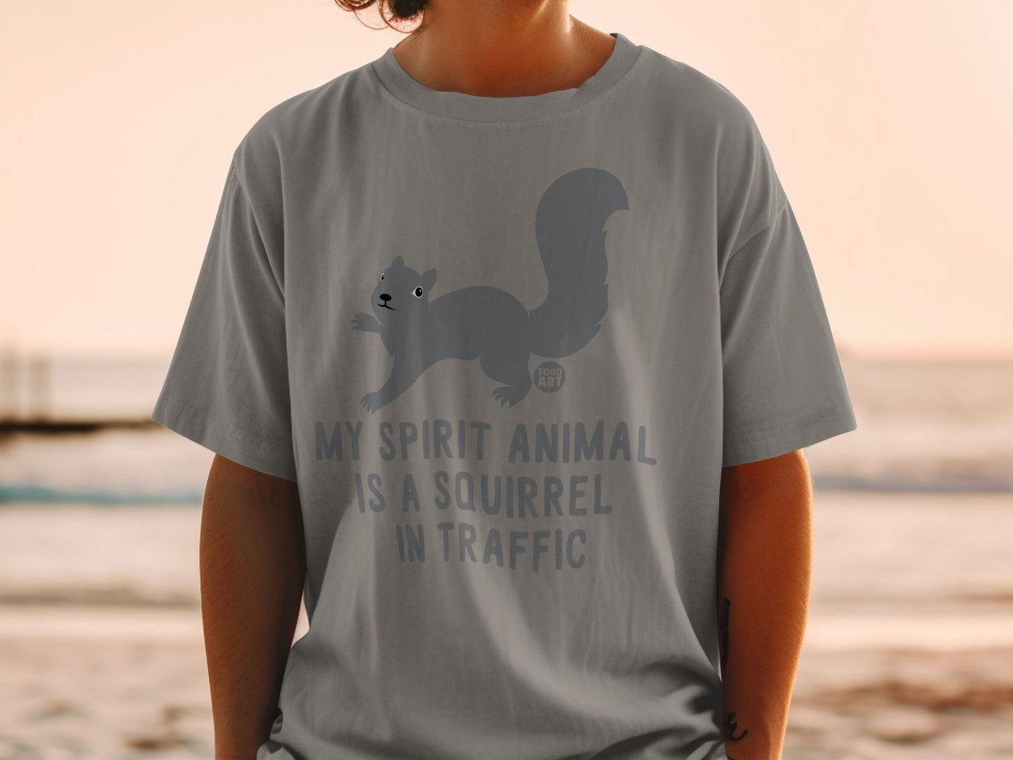 Gray t-shirt with a cartoon squirrel and text, "MY SPIRIT ANIMAL IS A SQUIRREL IN TRAFFIC".
