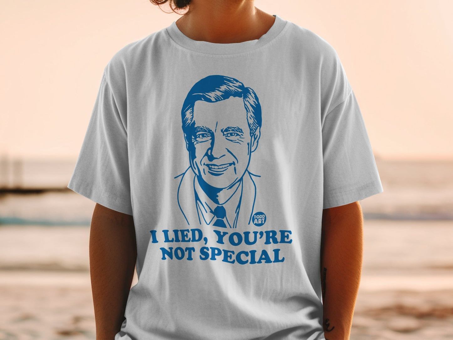 White t-shirt with a blue illustration of Mr. Rogers and the text "I lied, you're not special".
