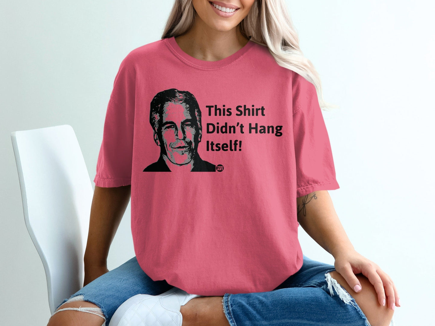 Pink t-shirt with portrait and text "This Shirt Didn't Hang Itself!"