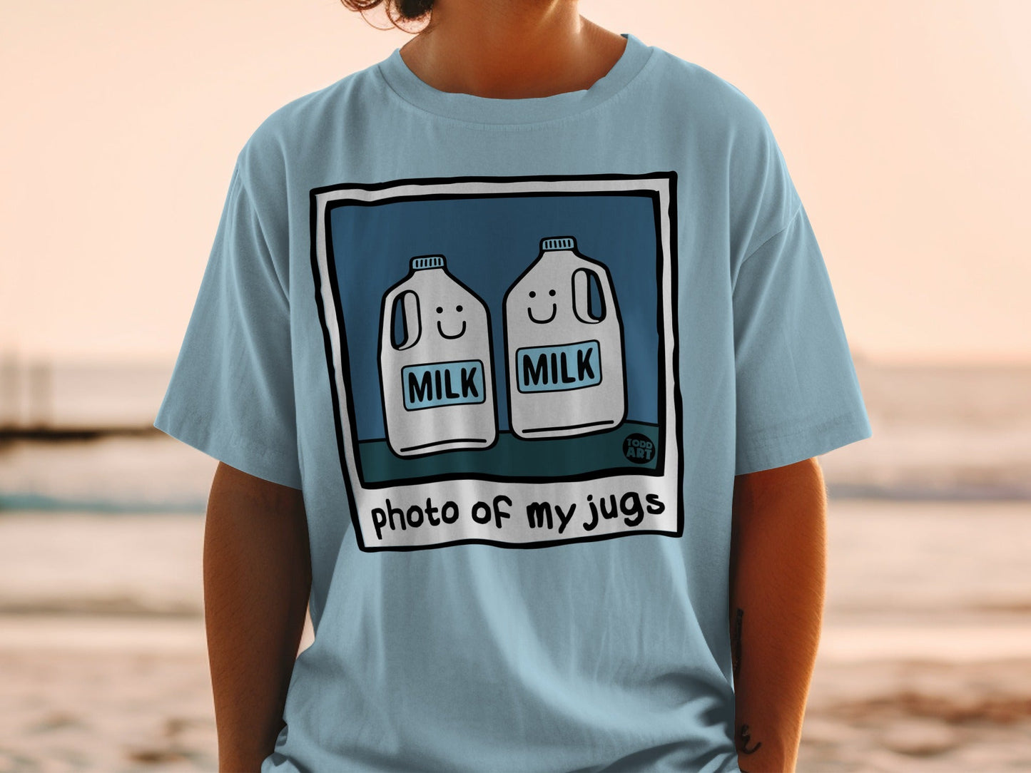 T-shirt with cartoon milk jugs wearing smiling faces.