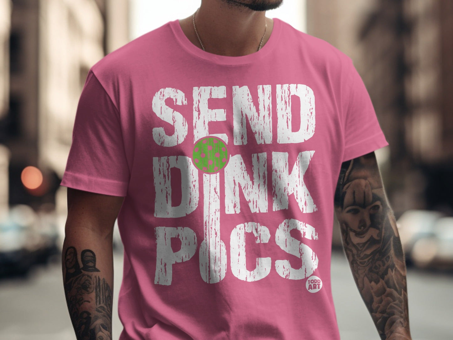 Pink t-shirt with white text "SEND DINK PICS" and a green pickleball.