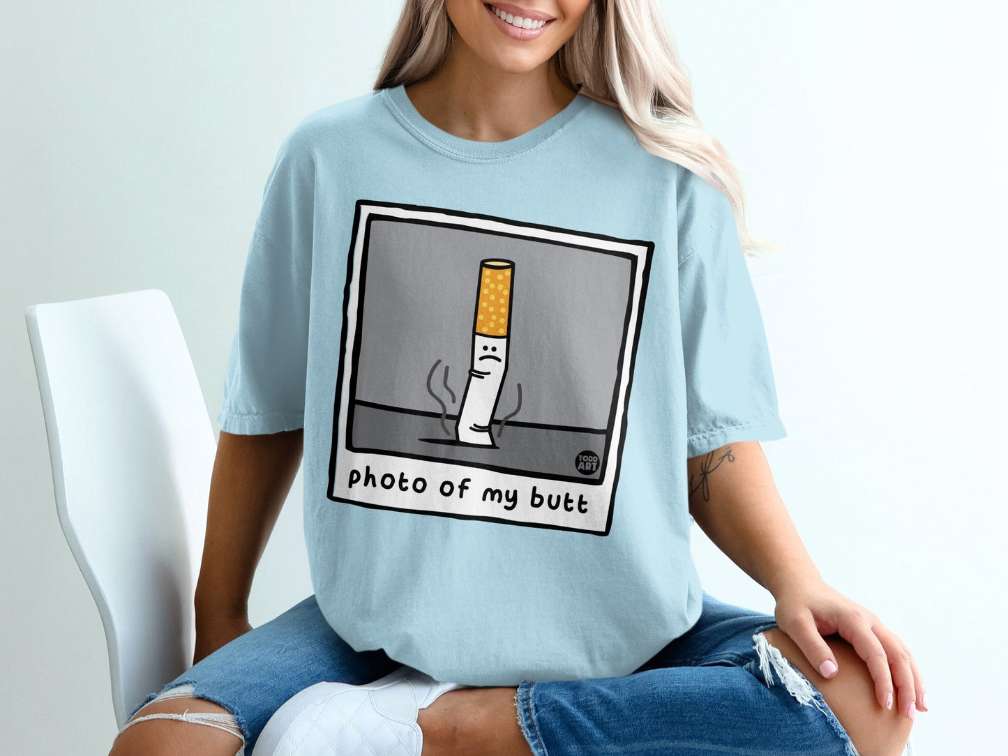 Light blue t-shirt with "photo of my butt" cartoon cigarette design.