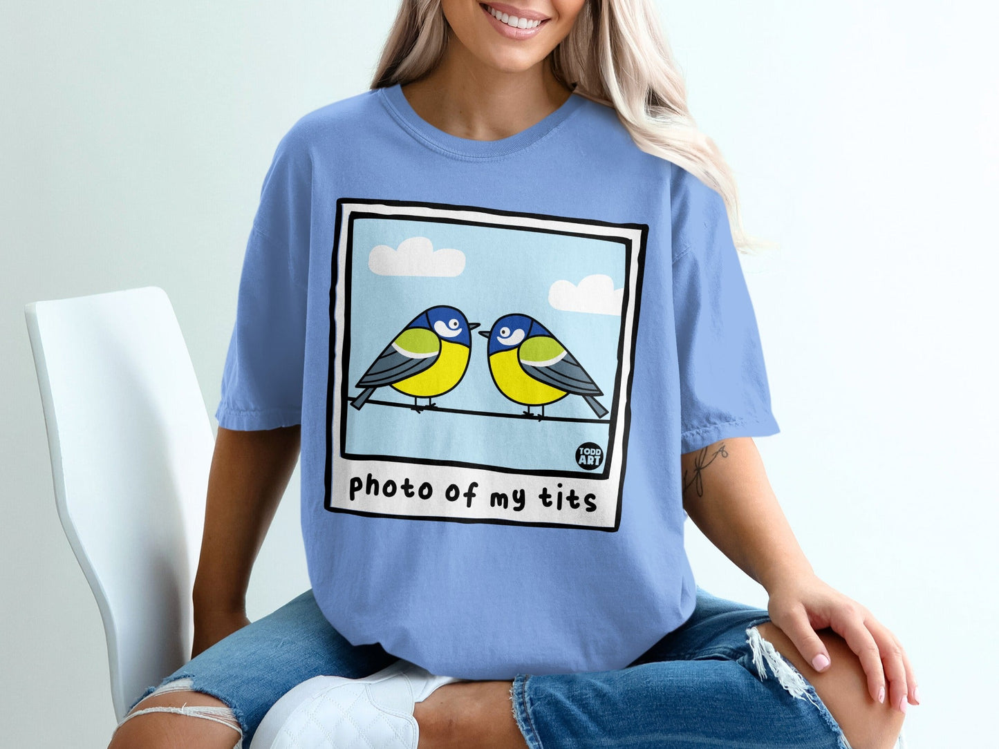 Two blue and yellow birds perched on a wire, with text that reads "photo of my tits".