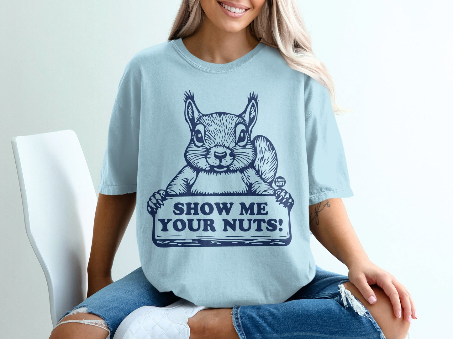 Light blue t-shirt with a squirrel holding a "Show Me Your Nuts!" sign.