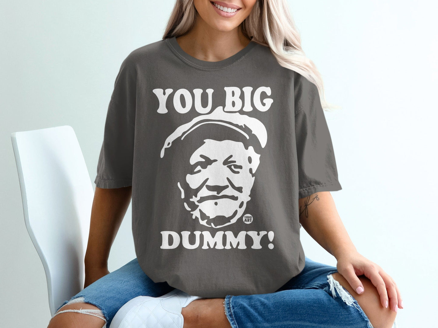 Charcoal t-shirt with "YOU BIG DUMMY!" and cartoon face graphic.