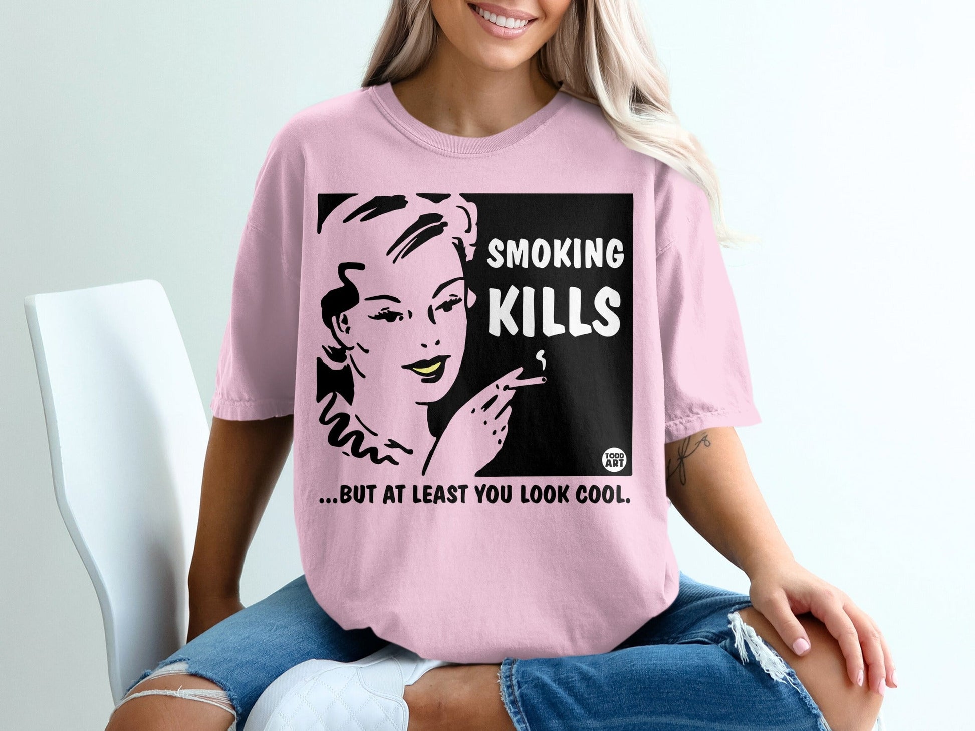 Pink t-shirt with "SMOKING KILLS...BUT AT LEAST YOU LOOK COOL" slogan and retro woman.