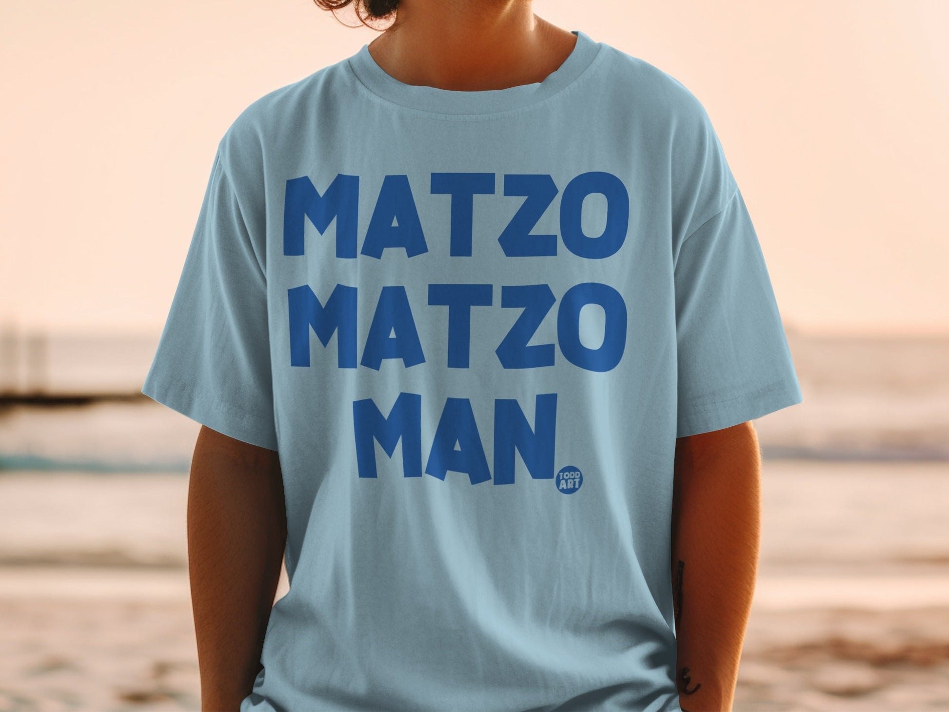 Light blue t-shirt with "MATZO MATZO MAN" in bold blue letters.