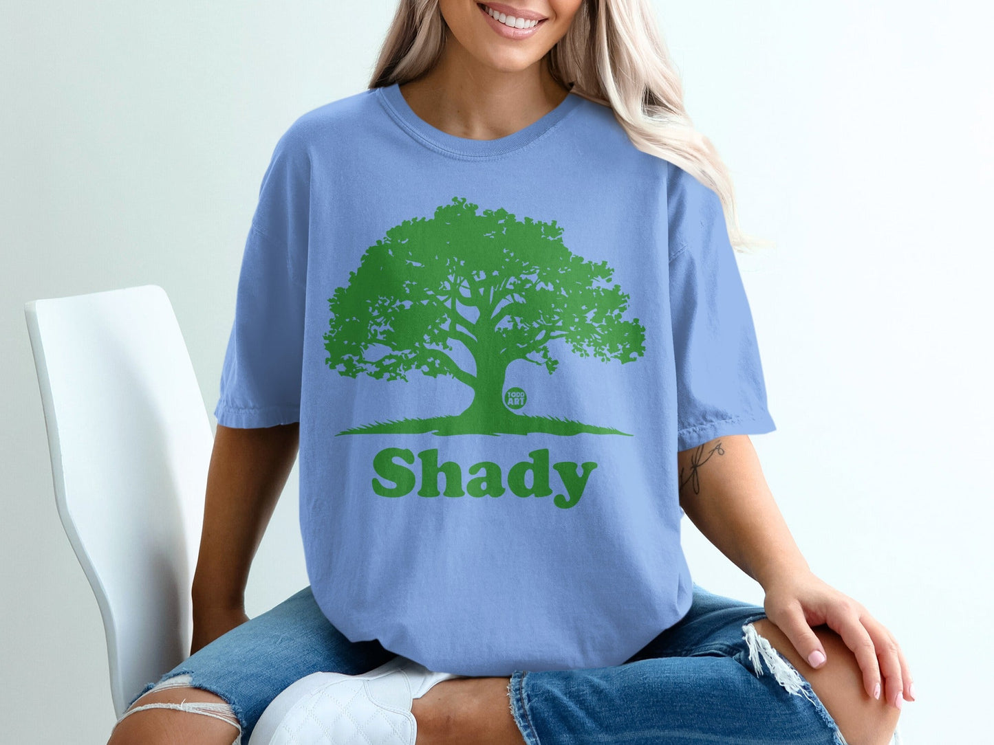 Blue t-shirt with large green tree graphic and "Shady" text.