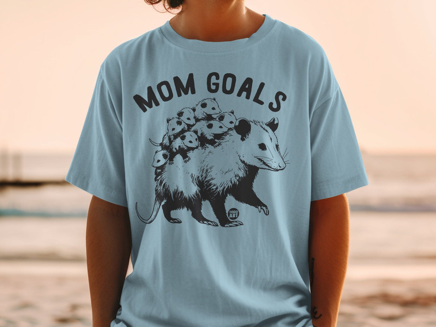 Opossum with babies on its back, "Mom Goals" text.