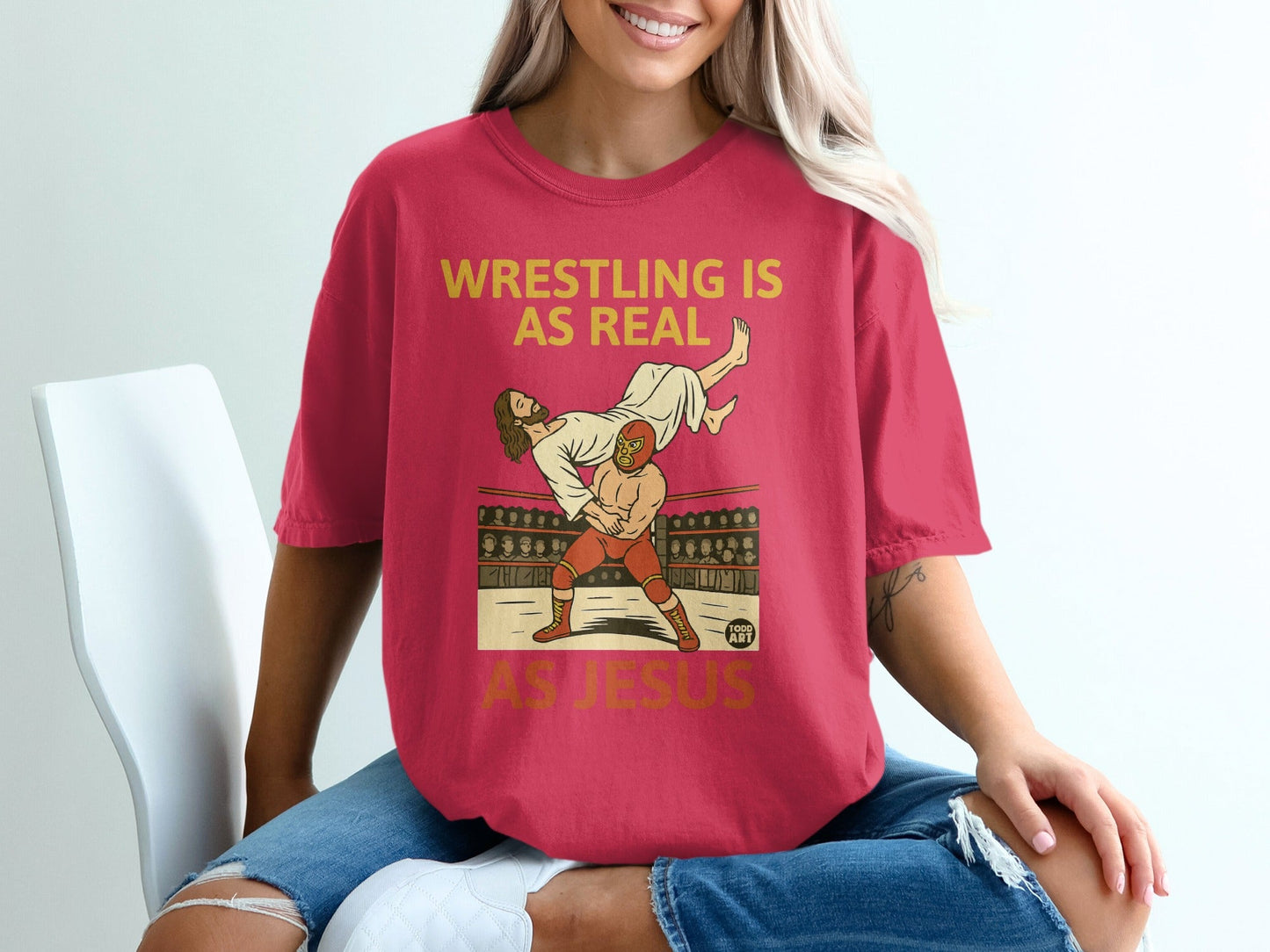 Wrestling is as real as Jesus graphic on a pink t-shirt.