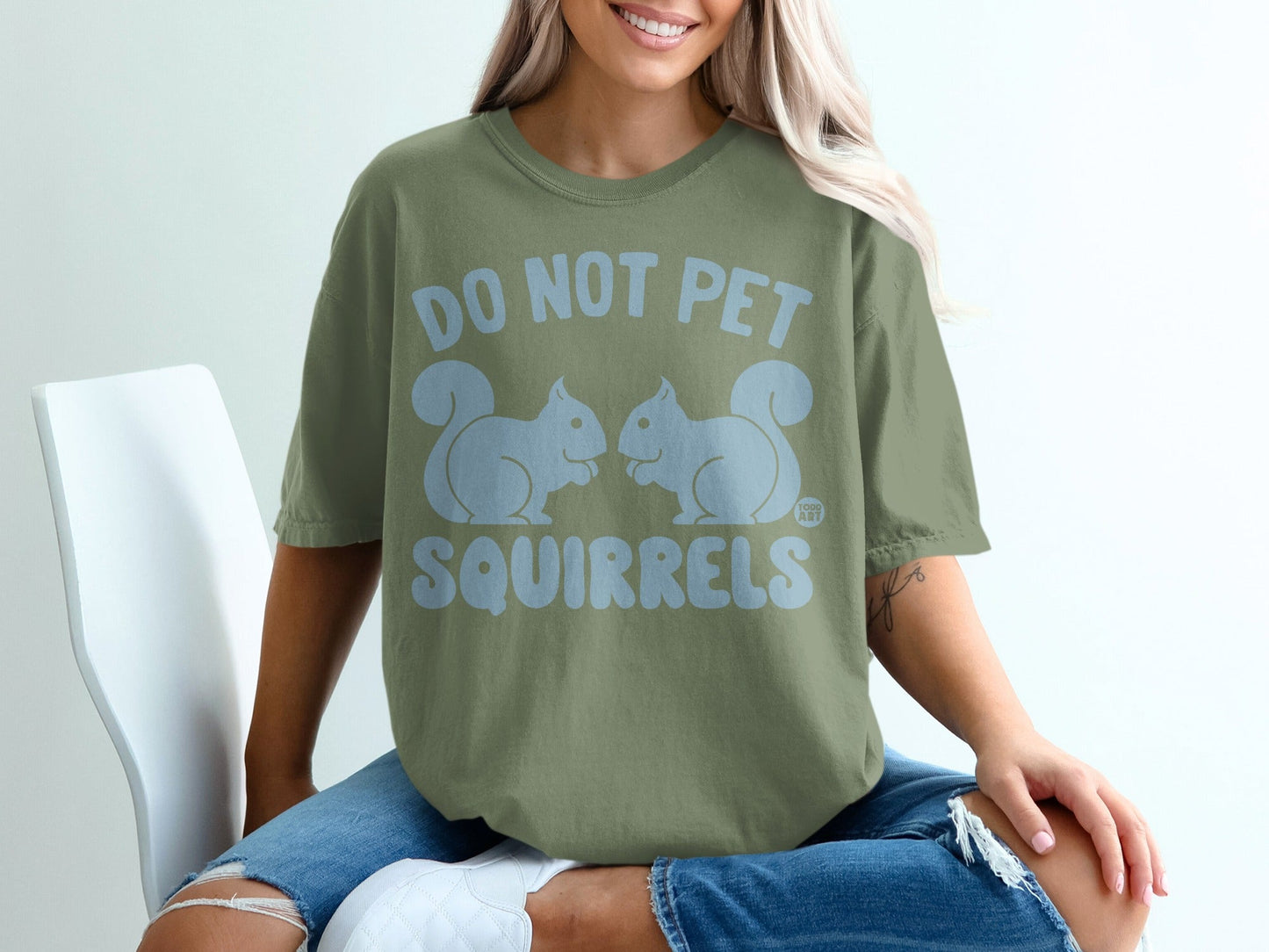 Green t-shirt with light blue text "DO NOT PET SQUIRRELS" and two squirrel graphics.