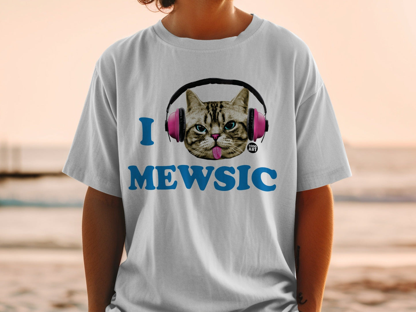Cat wearing headphones on t-shirt with "I MEWSIC" text.