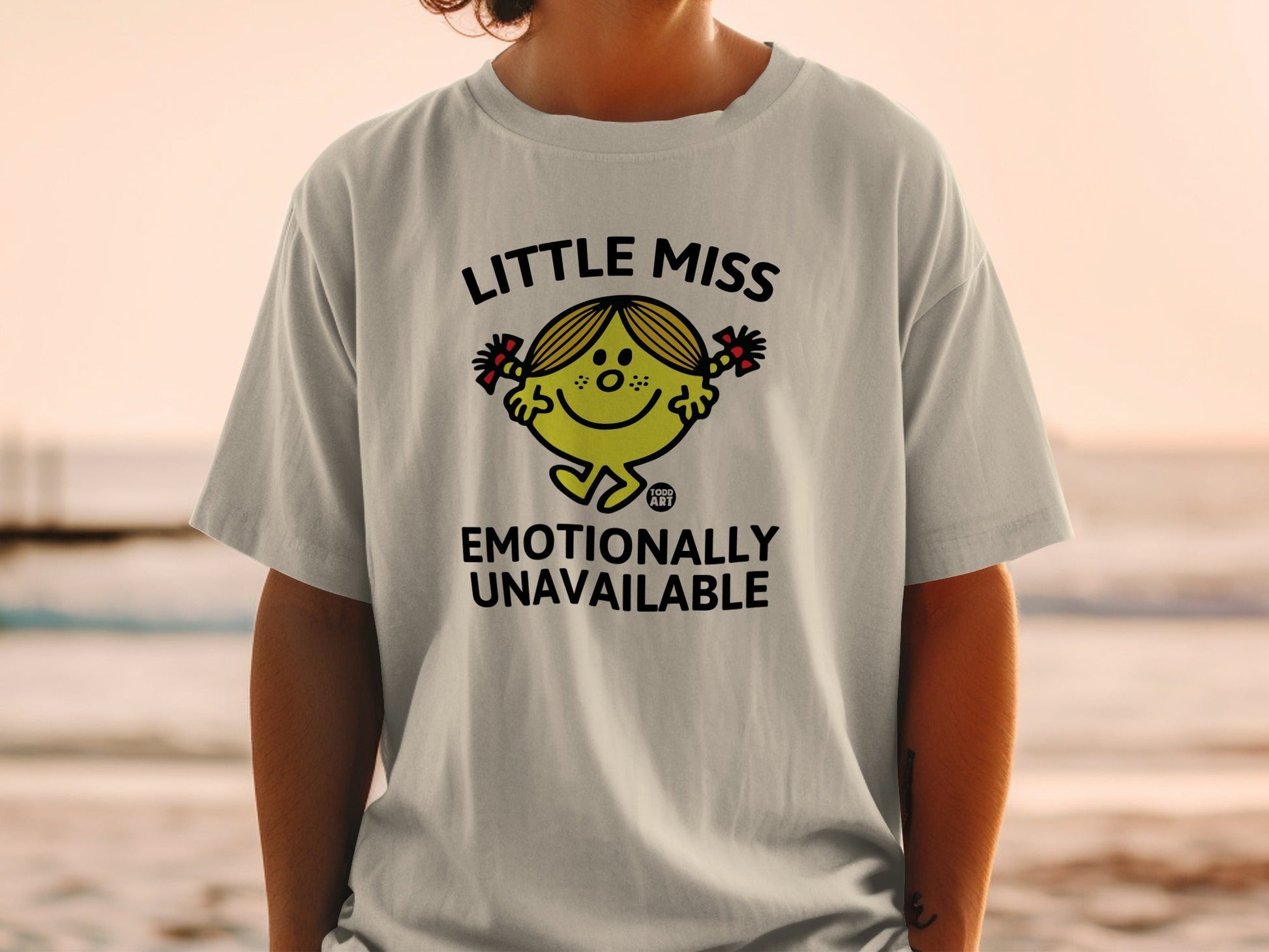 Little Miss Emotionally Unavailable graphic tee on a light grey t-shirt.