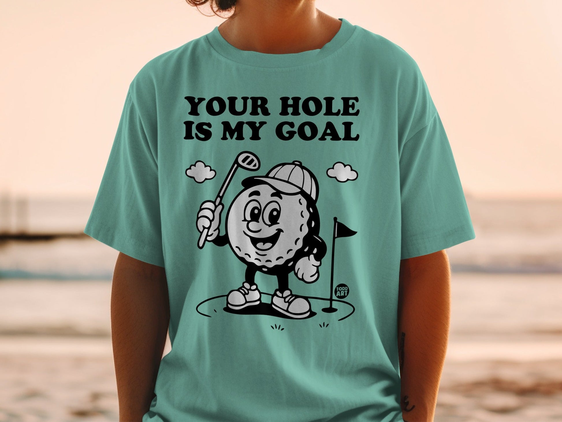 Golf ball character wearing a hat, holding a club, with text "YOUR HOLE IS MY GOAL".