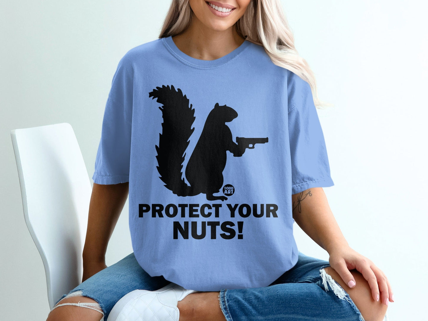 Squirrel holding a gun with "Protect Your Nuts!" text.