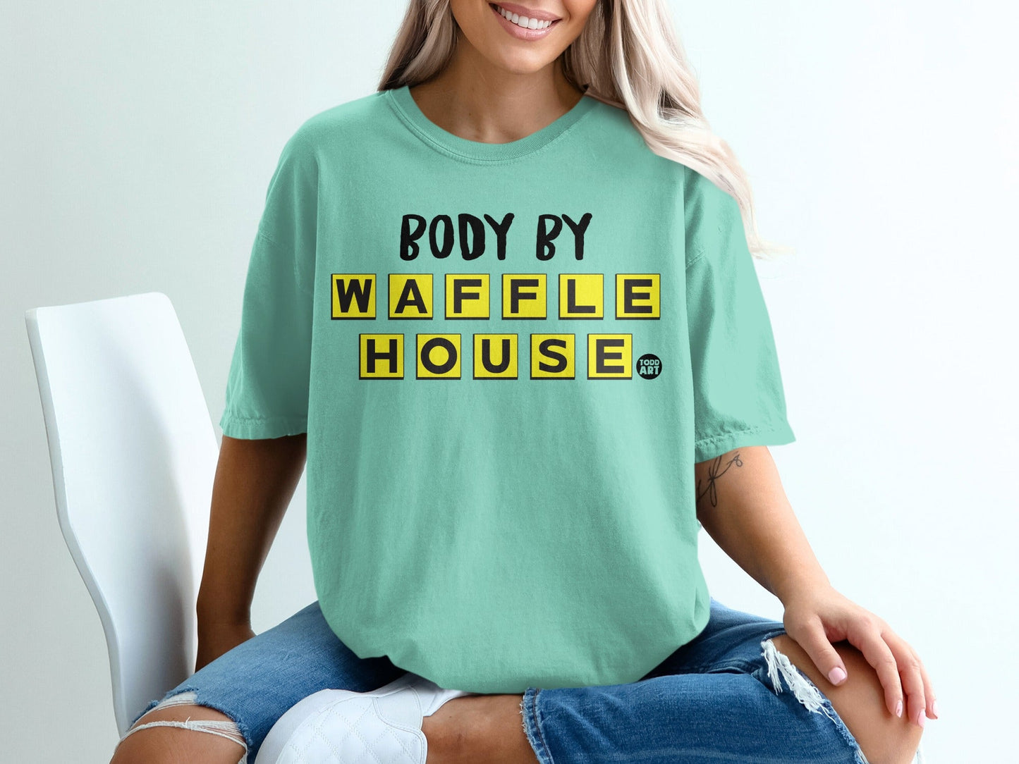 Teal t-shirt with yellow "BODY BY WAFFLE HOUSE" text.