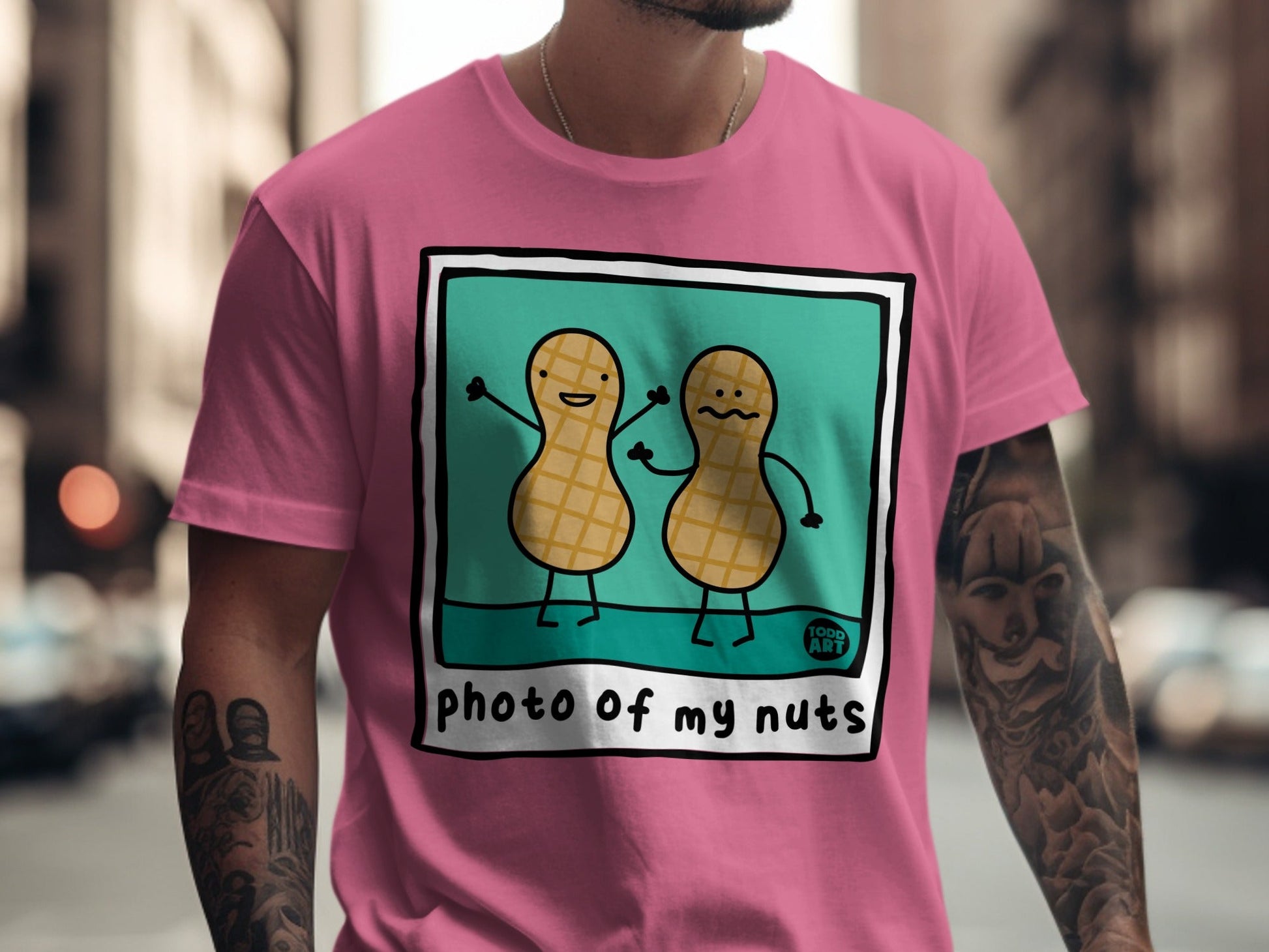 Two cartoon peanuts with smiling faces on a pink t-shirt.
