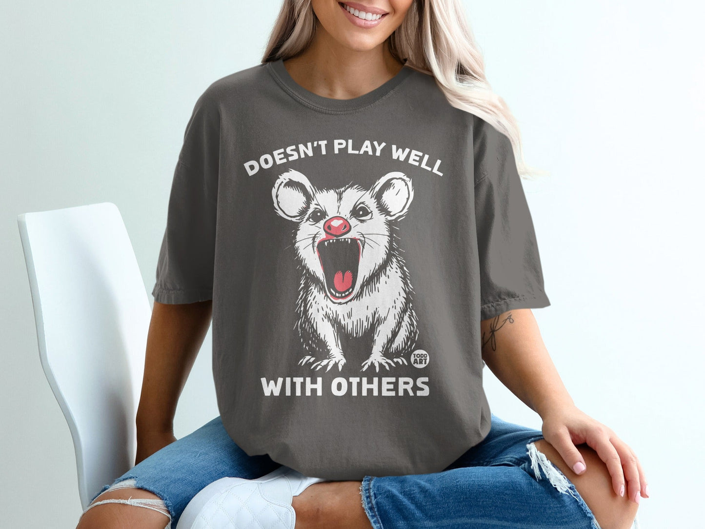 Dark grey t-shirt with white text and a screaming possum graphic.